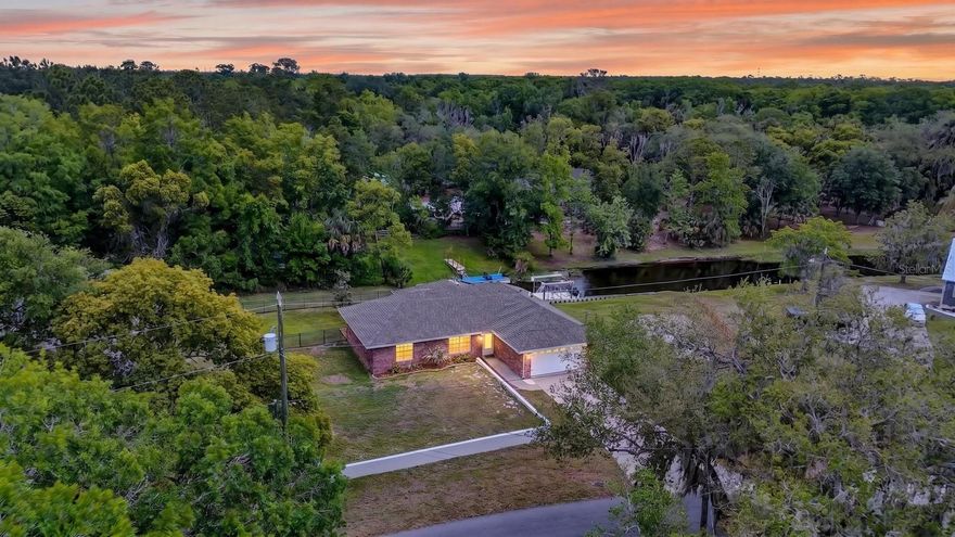 WATERFRONT home on DEEP WATER canal leading to Lake Beresford/St Johns River with a dock and 6000 lb BOAT LIFT. This isn't a house, this is a lifestyle! Walk out your screened back porch through your FENCED in back yard and hop on your boat!! This year 2000 build is BLOCK construction with a new hip roof in 2022. This home sits on .36 acres of HIGH and DRY land. Zero flood history flood zone X. Complete with true RIPERIAN RIGHTS. This is a 3 Bedroom 2 bath OPEN CONCEPT modern home complete with KITCHEN ISLAND, and custom closet systems in all the bedrooms. Enjoy amazing water quality with the new whole home WATER SOFTENER system. Updated HVAC system in 2018 will keep you ice cold on those summer afternoons! Premium location in Deland just 1 mile from the sun rail/amtrak station.