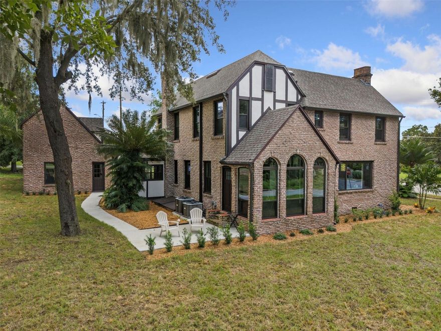 Step into the charm of this beautifully renovated 1927 Tudor Revival, carefully restored to preserve its original character. Featuring a unique 'weeping mortar' brick exterior, this home sits on a prime half-acre corner lot, boasting over 160 feet of waterfront with direct access to Lake Eustis via a newly built 30-foot dock. 

With over 2,600 square feet of living space, this home offers a stunning, fully remodeled kitchen with custom green craftsman cabinetry, quartz countertops, a farmhouse sink, intricate tile work, and a premium 36-inch commercial-grade range hood. All-new stainless steel appliances complete the modern kitchen. The original wood floors have been professionally refinished and stained a rich dark brown, complementing the home’s freshly painted, bright interior.

Off the kitchen, you’ll find the dining room and a large enclosed porch with expansive floor-to-ceiling windows, offering breathtaking lake views. To the left, the living room features original ceiling beams, two fandeliers, a custom-tiled fireplace framed by two stunning stained glass windows, and a brand-new window that frames the beauty of Lake Eustis.

Upstairs, you'll find three spacious bedrooms and two newly updated bathrooms with custom tile, refinished cast iron tubs, and new cabinetry and fixtures. A half-bathroom is conveniently located just off the foyer. The home also offers a large cellar basement with access from either the kitchen or an outside bulkhead door.

Above the detached garage, there’s a 300+/- square foot in-law suite, refreshed with a new kitchenette, mini-fridge, updated bathroom, and a mini-split system for comfort.

Recent updates include a complete electrical rewire with new panel, switches, outlets, lights, and fans throughout; a new septic system and drain field; a full plumbing repipe with updated fixtures; new double-pane windows; two new HVAC systems; a new roof; new rain gutters; a new oversized concrete driveway, path, and deck; all-new landscaping; and a newly rebuilt dock.

Over $300K has been invested in restoring this one-of-a-kind property, blending modern convenience with historic charm. Priced well below its recent appraisal, this gem is a rare find. Call your agent today to schedule a showing!

Eustis is a charming town in Lake County, FL, located 35 miles northwest of Orlando, near Mount Dora. Known for its historic downtown, tree-lined streets, and local shops, it sits on the shores of Lake Eustis, offering boating and fishing opportunities. Part of the Harris Chain of Lakes, which includes Lake Harris, Lake Dora, and Lake Griffin, the area is popular for outdoor activities, wildlife viewing, and its scenic beauty. Eustis offers a peaceful retreat with easy access to nearby cities.