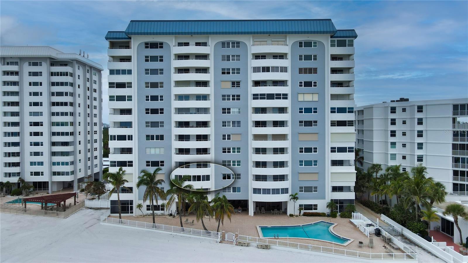 One or more photo(s) has been virtually staged. Motivated seller offering this Condo with Stunning water views of Lido Key Beach! Enjoy overlooking the Gulf of Mexico from every room in this third-floor condominium. This 2 bed/2 bath open floor plan has tiled floors throughout the living areas and has been recently remodeled to include smooth-finish drywall New HVAC system 2021, and New Hot Water Tank in 2021. The kitchen features exquisite quartz countertops and provides additional cabinetry and closet space, ensuring ample storage capacity. A breakfast bar and writing nook round out the space. Both bedrooms have wood flooring and each feature a renovated ensuite bath. The main bedroom offers a walk-in closet, and the bath includes a built-in vanity and shower. The guest bathroom has a walk-in shower. The unit boasts its own washer and dryer area tucked away in a closet of the guest bedroom. A gorgeous west-facing covered balcony features Recently added hurricane enforced windows (2023) and for added protection electrically operated hurricane shutters on all the windows and sliding glass doors. Key Towers South is a meticulously maintained, secured, beach-front building located on the southern end of Lido Key. Beyond the beautiful lobby area, you will find a community space featuring a fitness room, library, and social room with a kitchen. A gated, heated pool overlooks the beach. Additional amenities include shower and sauna room, bike rack storage, and on-site staff members. The unit also comes with an assigned carport parking space. Lido Key is close to St. Armand’s Circle and downtown Sarasota, where you’ll find shopping, restaurants and a lively cultural scene. The nearby nature park offers picnic areas, walking trails and plenty of outdoor activities.