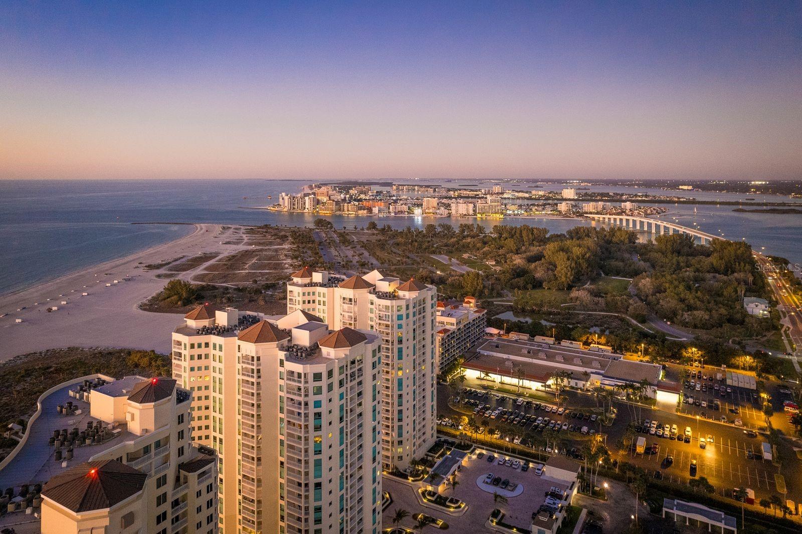 You deserve a condo at the beach. It’s best for your health!Prepare to be amazed by this beautiful 3 bedroom 2.5 bathroom condo on Clearwater Beach. Freshly painted and light and bright. Get Ready to write your story here at The Gorgeous Grande. The eat-in kitchen with all white cabinetry provides for ton of storage. The Primary suite is Large with a private porch, 2 closets, one walk-in, one oversized and complete with a spa-like en-suite bathroom. The primary bathroom has a double vanity, a large shower with 2 shower heads, a separate water closet with a toilet and a bidet. The second room is an en-suite. The third bedroom has beautiful built-in custom cabinetry and can be used as a bedroom, den or office. HVAC 2021 & Fresh paint 2025. There is a dedicated parking space & BONUS there is also a deeded Garage! The large balcony on this corner unit boasts the most opulent views from every angle allowing you to Enjoy the perfect sunrise every day. There are million dollar views for days of The Gulf, inter-coastal, & City scape views from 2 different wrap around porches. Immerse yourself in the Epitome of Luxury at the finest resort style property in all of Tampa Bay. The Grande on Clearwater Beach is a 14 acre property loaded with all of the amenities. This Gated community has 24 hour security and concierge service throughout the week. Here you will enjoy 2 extra large pools, a HUGE Jacuzzi, restrooms with showers, 2 outdoor grilling and entertainment areas perfect for hosting friends & family. There are 2 indoor gyms, 2 clubhouses, tons of covered parking, 2 tennis courts, dog walk areas and BEST of ALL Private beach access. The Lush landscaping and lighting completes the feeling of a True Tropical Paradise. Just steps away from Resteraunts & shopping. As a resident of the grand you can enjoy a reduced priced membership to the Clearwater Sailing Center, located across the street where you may enjoy sailboats and other watercraft. The trolley stop is just out the front gate giving you the freedom to enjoy all fun things Clearwater and surrounding beaches has to offer. The Grande is just a short trip to St. Petersburg & Tampa International airports. Call to schedule your private viewing today.