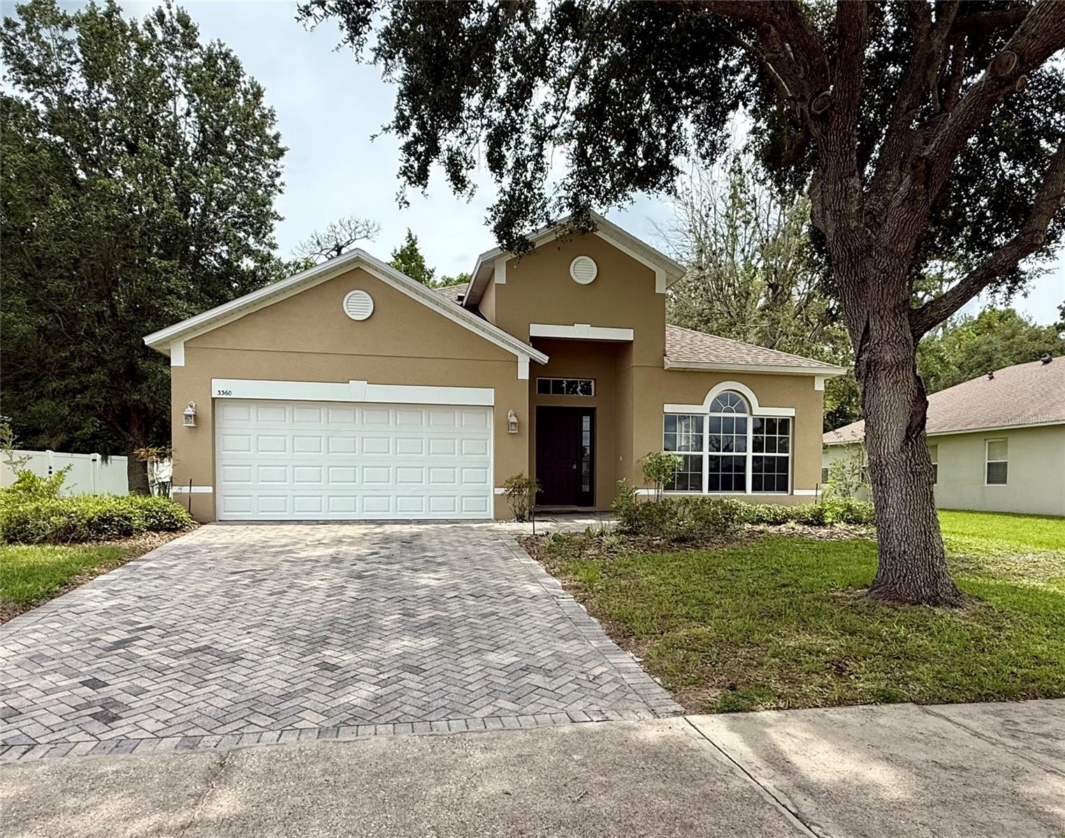 This beautifully maintained 1,952 sq ft home sits on a quiet cul-de-sac with peaceful conservation views. Featuring a desirable split floor plan, this home offers two spacious living areas, formal dining, and a bright eat-in kitchen with brand-new stainless steel appliances, solid wood cabinetry, and a breakfast bar. The large primary suite includes a walk-in closet and a private bath with garden tub and separate shower. A very split plan ideal for families or privacy. Enjoy Florida living on the covered lanai overlooking a serene pond and wooded area—no rear neighbors! Other highlights include a paver driveway, 2-car garage, mature landscaping, and low HOA fees. Located in a gated community close to shopping, dining, schools, and downtown Mount Dora. Move-in ready and waiting for you!