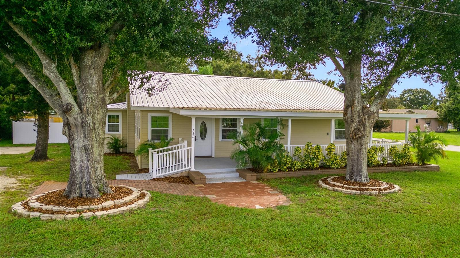 Welcome to this beautifully renovated home in Lake Wales, perfectly positioned on a generous .61-acre corner lot. With a durable metal roof and a spacious covered front porch overlooking a peaceful pasture, this home offers the charm of country living with no neighbors across the street to interrupt the view. The backyard is designed for both relaxation and functionality. It is fully fenced, with a separately enclosed area ideal for a dog run, and features a wood deck overlooking the yard. Whether you’re enjoying evenings at the picnic tables by the firepit, working on projects in the large detached shed, or simply appreciating the privacy and space, this outdoor retreat has something for everyone. Inside, this home has been thoughtfully updated and offers plenty of room. Most of the living spaces and bedrooms have blinds already installed. The spacious dining room with bay windows creates the perfect setting for family meals or entertaining, while the large kitchen offers an island with seating, as well as a bonus countertop area that makes an ideal coffee bar or cocktail station. A half bath and utility room are conveniently located just off the kitchen. The primary suite provides comfort and convenience with a bathroom featuring his and her sinks, a makeup vanity, and a linen closet. In addition, this property offers a fantastic in-law suite setup with its own private entry, living space, kitchen, bedroom, and bathroom. This area also includes a walk-in closet and its own washer and dryer, making it a true independent retreat for extended family or guests. From its flexible interior to its welcoming outdoor spaces, this Lake Wales home offers the perfect balance of charm, space, and functionality, ready to be enjoyed by its next owners. USDA FINANCING AVAILABLE FOR ELIGIBLE BUYERS, WITH NO MONEY DOWN. CALL TODAY FOR MORE DETAILS.