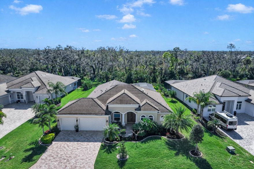 Welcome to a refined Florida lifestyle where elegant design, privacy, and effortless indoor-outdoor living come together on a nearly half-acre homesite backed up to a preserve within the gated Reserve at Twin Rivers. 

From the moment you arrive, the home’s striking curb appeal captivates, featuring lush, manicured landscaping, a wide pavered driveway, and a three-car garage. Built by Medallion Homes, this residence offers over 4,600 square feet of covered living space, combining timeless craftsmanship with modern peace of mind, including HURRICANE-IMPACT WINDOWS AND SLIDERS throughout, a TILE ROOF, GUTTERS and a brand-new WHOLE-HOUSE GENERATOR powered by a 500-GALLON BURIED PROPANE TANK.

Step inside to discover elegant architectural details, with TRAY CEILINGS and CROWN MOLDING throughout. The front of the home features a formal dining room, inviting sitting room, and a private office with glass French doors and built-in shelving. Ideal for hosting guests or working from home.

Toward the back, the home opens effortlessly to the outdoors. Sliders from the living room, kitchen, primary suite, and bonus room provide seamless access to a resort-style lanai, HEATED SALTWATER POOL, and SPA. Surrounded by lush palms for privacy, the lanai includes an OUTDOOR KITCHEN, the perfect for alfresco dining, entertaining, or relaxing in a tropical retreat.

The kitchen is both beautiful and functional, featuring a large cooking island, upgraded cabinetry, quartz countertops, bar-top seating, a walk-in pantry with built-in shelving, and a butler’s pantry. The café dining area is highlighted by an aquarium window, bringing a touch of nature inside.

The split floor plan offers privacy and comfort. The primary suite is a serene retreat with sliders to the pool, dual walk-in closets, and a spa-inspired en-suite bathroom with dual vanities, a dedicated makeup area, large walk-in shower, and a private water closet with a separate porcelain bidet. Two bedrooms share a Jack-and-Jill bath with tub, while a fourth bedroom near the bonus room enjoys a full pool-access bathroom with shower.

The BONUS ROOM, located off the living room, is a true showpiece featuring a COFFERED ceiling, BUILT-IN BAR with WINE REFRIGERATOR, dramatic STACKED STONE ACCENT WALL, BUILT-IN ELECTRIC FIREPLACE, and sliders opening directly to the lanai and pool. The perfect place for entertaining or unwinding.

Located in a GATED community with NO CDD fees and low HOA FEES THAT INCLUDE CABLE AND INTERNET, this exceptional property offers rare privacy while remaining close to Parrish, Bradenton, Lakewood Ranch, premier shopping and dining, and the Gulf Coast beaches.

This is refined Florida living at its finest where elegant interiors, expansive indoor-outdoor spaces, and thoughtful upgrades create a truly extraordinary place to call home.
CLICK on the links for VIDEO and 3D TOURS!