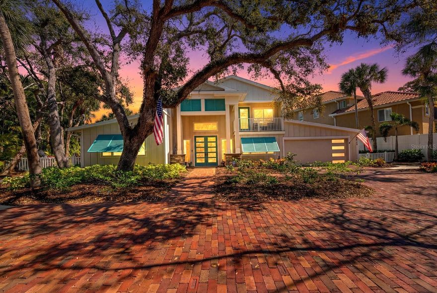 Exceptional new waterfront offering on the Grand Canal of Siesta Key. Located on a quiet, picturesque canopy road, this coveted property delivers deep-water boating, and a new 31' dock and 10,000 lb. lift. Rare 100' stretch of unspoiled waterfront frontage. Quick access to Sarasota Bay and the Gulf. Designed for elevated coastal living, the residence offers expansive living areas, elegant finishes, and seamless indoor-outdoor flow ideal for entertaining and everyday luxury. Positioned on a double lot, with a stately motor court surrounded by opulent landscaping, the home offers a welcoming atmosphere. The kitchen is expansive, beautifully redesigned, and built for hosting large gatherings; a Culinary Haven with a Chef's Island as the centerpiece, complete with top-of-the-line appliances, including a Wolf 6-burner gas range, a Sub-Zero refrigerator, and a secondary Sub-Zero refrigerator is also included. A nugget ice maker, and wine fridge in the dining room's dry bar sets the tone, with a luxurious dining room offering a large space for dinner parties, also could double as a formal living room. There are two primary suites, one downstairs, and one upstairs. The downstairs suite is perfect for guests or an in-law unit. The second-floor primary suite is a private retreat, elevated above it all and wrapped in natural light. Large windows frame tranquil canal views and lush, mature landscaping, creating a serene, tree-lined outlook that feels both peaceful and secluded. The main primary bath, a dream en-suite bath, a luxurious area that incorporates dual sinks, a rainfall glass enclosed shower, separate soaking tub, and private water closet. A voluminous walk-in closet, with a built-in vanity, acts as the quintessential, functional anchor. An additional 1 to 2 guest bedrooms on the second floor, with a 4th full bath. 2nd floor loft/game room is a perfect room for a getaway, or read a book on its outdoor terrace. Back downstairs is a home office, a private workspace. The first floor family room is a large media room with sliders to access the lanai, and the two-story pool cage that will be a family favorite, with its salt water pool and spa. Step outside and fire up the grill. The expansive outdoor living area is designed for effortless gatherings and all-day enjoyment. An outdoor kitchen with a built-in grill, and eat-up bar, allows for making it easy to host everything from casual lunches to evening cookouts. Multiple table spaces offer comfortable shaded seating, perfect for dining, games, or lingering conversations. Completely renovated estate. This beautiful home is essentially brand new. A grand space that's Just minutes from the sugar-sand shores of world-famous Siesta Key Beach, once again voted the number 1 beach in America by TripAdvisor, along with premier dining, night life at Siesta Key Village, and endless boutiques for shopping. One of Siesta Key's most desirable waterfront locations. Come experience a serious boater's dream come true!