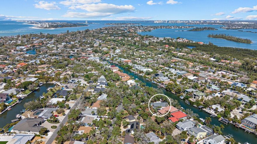 Exceptional new waterfront offering on the Grand Canal of Siesta Key. Located on a quiet, picturesque canopy road, this coveted property delivers deep-water boating, and a new 31' dock and 10,000 lb. lift. Rare 100' stretch of unspoiled waterfront frontage. Quick access to Sarasota Bay and the Gulf. Designed for elevated coastal living, the residence offers expansive living areas, elegant finishes, and seamless indoor-outdoor flow ideal for entertaining and everyday luxury. Positioned on a double lot, with a stately motor court surrounded by opulent landscaping, the home offers a welcoming atmosphere. The kitchen is expansive, beautifully redesigned, and built for hosting large gatherings; a Culinary Haven with a Chef's Island as the centerpiece, complete with top-of-the-line appliances, including a Wolf 6-burner gas range, a Sub-Zero refrigerator, and a secondary Sub-Zero refrigerator is also included. A nugget ice maker, and wine fridge in the dining room's dry bar sets the tone, with a luxurious dining room offering a large space for dinner parties, also could double as a formal living room. There are two primary suites, one downstairs, and one upstairs. The downstairs suite is perfect for guests or an in-law unit. The second-floor primary suite is a private retreat, elevated above it all and wrapped in natural light. Large windows frame tranquil canal views and lush, mature landscaping, creating a serene, tree-lined outlook that feels both peaceful and secluded. The main primary bath, a dream en-suite bath, a luxurious area that incorporates dual sinks, a rainfall glass enclosed shower, separate soaking tub, and private water closet. A voluminous walk-in closet, with a built-in vanity, acts as the quintessential, functional anchor. An additional 1 to 2 guest bedrooms on the second floor, with a 4th full bath. 2nd floor loft/game room is a perfect room for a getaway, or read a book on its outdoor terrace. Back downstairs is a home office, a private workspace. The first floor family room is a large media room with sliders to access the lanai, and the two-story pool cage that will be a family favorite, with its salt water pool and spa. Step outside and fire up the grill. The expansive outdoor living area is designed for effortless gatherings and all-day enjoyment. An outdoor kitchen with a built-in grill, and eat-up bar, allows for making it easy to host everything from casual lunches to evening cookouts. Multiple table spaces offer comfortable shaded seating, perfect for dining, games, or lingering conversations. Completely renovated estate. This beautiful home is essentially brand new. A grand space that's Just minutes from the sugar-sand shores of world-famous Siesta Key Beach, once again voted the number 1 beach in America by TripAdvisor, along with premier dining, night life at Siesta Key Village, and endless boutiques for shopping. One of Siesta Key's most desirable waterfront locations. Come experience a serious boater's dream come true!