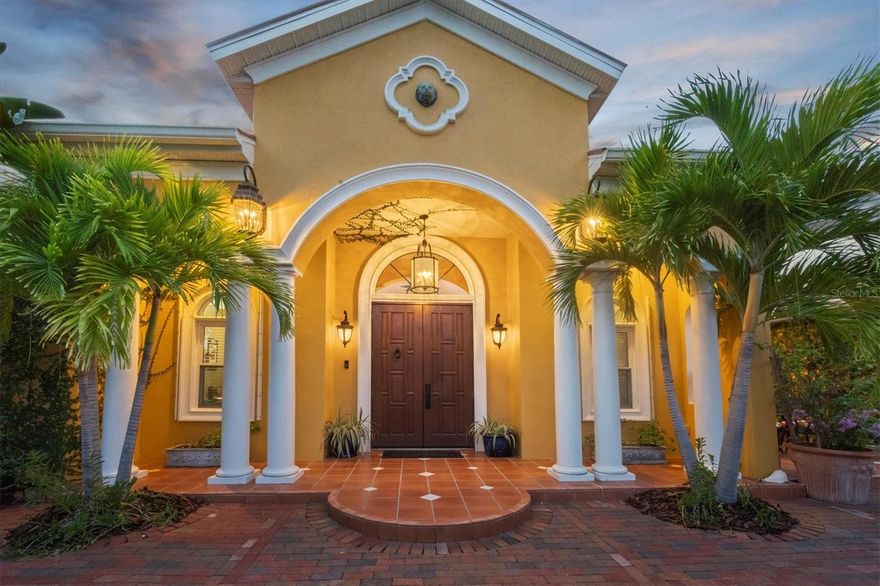 Nestled amidst the tranquil charm of the esteemed Bird Key community, this residence epitomizes the essence of coastal living, seamlessly intertwining outdoor allure with luxurious interiors. Upon entry, the grandeur of the expansive great room captivates with soaring ceilings, intricate crown molding, and a spectacular wall of glass doors that open onto the incredible outdoor space. The professional-grade kitchen embodies luxury with its high ceilings, an oversized island featuring granite countertops, a prep sink, butcher block, and a striking stone accent wall and is equipped with top-tier stainless steel appliances, including a Sub-Zero refrigerator, Wolf range, and beverage cooler. Abundant neutral-toned wood cabinetry and the bar-height seating for six create the perfect setting for entertaining and flows into the adjacent dining area, enhanced by French doors for indoor-outdoor living at its finest. The expansive primary suite boasts abundant natural light through the glass-paned door and strategically placed windows, preserving utmost privacy amidst the soaring ceilings. The spa-like primary bathroom is complete with a vanity boasting dual sinks and seating, a luxurious soaking/jacuzzi tub and an opulent walk-in spa and steam shower. A spacious closet offers ample built-in storage and hanging space. Step outside to a coastal sanctuary that defines relaxation and entertainment. The patio and pool deck offers an inviting outdoor kitchen, a built-in grill complemented by granite countertops, and a fully operational wood-burning pizza oven. Encircled by Florida-friendly landscaping, the private, serene garden is an oasis with local foliage featuring mature avocado, mango, and olive trees, adding to the coastal ambiance. Other features of this remarkable home include four guest bedrooms, one with glass-paned French doors for private access to the patio, two full guest bathrooms, an office, one half-bath, and a circular drive that leads to a two-car garage with epoxy flooring, purpose-designed cabinets, and dedicated storage for outdoor essentials. Although originally constructed in 1970, a significant update was done in 2000, and more recent upgrades include two newer AC units and two newer water heaters. Embrace the epitome of coastal outdoor living, where sophistication effortlessly dances with leisure at every turn. Please note that select fixtures and decorative items are excluded from the sale. Seize this unparalleled opportunity to claim your slice of coastal paradise at 614 Owl Way!