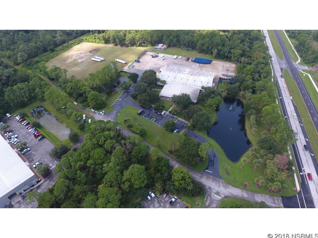 Prime US HWY US 1 location, 33,000 sqft manufacturing-office facility ready for your business. Approximately 24,000 sqft manufacturing and 9,000 sqft office space, with 1.8+/- acres of fenced concrete outside storage/truck yard. Double Truck well, with Serco-2,000lbs Load Warrior dock lift. Shipping dock-high and safe room / vault. Shop area includes 25' ceiling height, 4 overhead doors (12' X 14'), covered loading dock high area, 3-phase power with emergency shut-off. Security, fire sprinkler system, in office and warehouse. Building may be expanded. Office space features 9' ceilings, reception area, glass offices, cafeteria, his/hers lockers, and executive suites. Building/Real Estate for sale only, equipment not included, however, negotiable are two 3-Ton overhead trolley cranes, (2) paint and powder coat booths, (2) shot pellet blasters, air compressors and racking/storage equipment. Other equipment and furnishings onsite not listed are not included in sale, however are negotiable. Available and Adjacent is vacant 37+/-acres (industrial zoning) can be purchased for expansion or further investment. Established Marine (Boston Whaler) & Trailer (Karavan Trailers) Manufacturers nearby. ;Water: City
