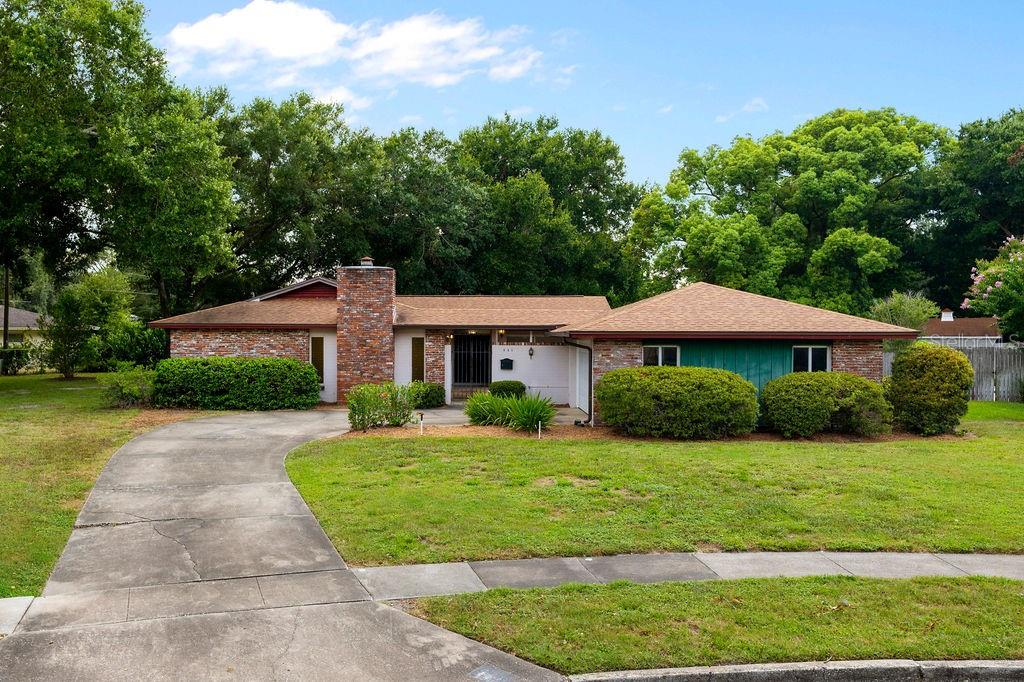 Mid-Century Modern vibes in this spacious 3 bedroom, 2 bathroom home with an innovative courtyard design that offers scenic views of the expansive lot from almost every room. The house is nestled under a canopy of mature trees on one of the largest lots in Winter Park Pines. Kitchen and baths are original but recent updates include: ROOF 2019, HVAC 2017, REPLUMBED 2009, GARAGE DOOR REPLACED, LAMINATE FLOORING 2014, INTERIOR PAINT 2025, UPDATED VINYL WINDOWS AND SLIDING DOORS 2015(MOST). The L-shaped formal living and dining rooms feature terrazzo floors and the living room has a vaulted ceiling and sliding doors into the private courtyard. The kitchen features a pass-through window into the courtyard for all of your outdoor entertaining options as well as a nook space ideally suited for a booth, breakfast table or a special piece of furniture. The adjacent family room is anchored with a brick wood burning fireplace and hearth, and another set of sliding doors into the courtyard. The primary suite has a large walk-in closet, a spacious en-suite bath and sliding doors overlooking the enormous rear yard. The house and lot have endless potential and are ready for your personal touch. The oversized lot is perfect for a pool, swing set, pets or sporting activities. Ideally situated just minutes from the shops and restaurants of Park Avenue, Rollins College, UCF and Full Sail Universities, the Cady Way Trail, Winter Pines Golf Club, and a short drive to downtown Orlando and Orlando International Airport.