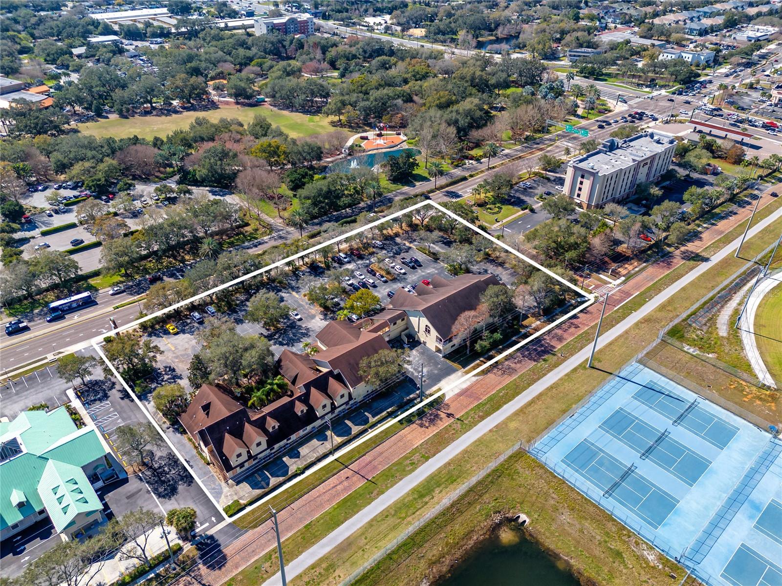 Located at 300 East Bay Dr in Largo, FL, this commercial property offers a rare strategic investment opportunity for developers and commercial investors. Positioned on a 2.52-acre site directly across from Largo Central Park, the property serves as a key entry point to the downtown corridor, highlighting its significance in the area's urban development landscape.
The site is currently zoned for high-density mixed-use development, allowing for up to 8 floors with the potential to feature up to 112 residential units alongside commercial spaces such as restaurants, offices, and retail outlets. This flexibility presents a unique opportunity to contribute to the area's growth and vibrancy, aligning with the area's increasing demand for mixed-use development.
Presently, the property hosts two commercial buildings, with a combined total of over 33,287 heated square feet. Both buildings are tenant-occupied. This existing infrastructure not only generates immediate income but also offers potential for redevelopment or integration into a larger project. The site boasts an excellent on-site parking ratio of 5 spots per 1,000 square feet, catering to both current and future occupancy needs.
With a daily traffic count exceeding 42,000 vehicles, the location guarantees high visibility and accessibility. The limitless development potential of this site, combined with its strategic position and existing amenities within the downtown corridor makes it an attractive proposition for corporations, developers, and investors aiming to capitalize on Largo's growth trajectory. Call today for further detail or to schedule a private viewing.