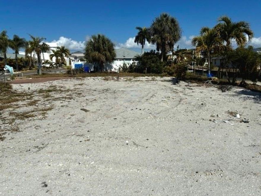 Exceptional opportunity to acquire a canal-front homesite in the highly desirable community of Longboat Key. This property offers 129 feet of canal frontage, deeded beach access to white sand beaches of the Gulf, and a recently issued building permit for a custom single-family residence. Property improvements include an upgraded seawall, boat dock, pool structure, water connection, geotechnical study, and complete land and building surveys. Direct boating access to Sarasota Bay and the Gulf makes this an ideal location for boating
enthusiasts. Permitted architectural and engineering plans are included for a custom-designed residence totaling 3,132 square feet under air, allowing construction to begin immediately. The design features 4 bedrooms, 4.5 bathrooms, open floor plan, outdoor lanai, 2 balconies, canal-facing terrace, and a 2-car garage. The balconies are perfectly positioned to capture sunrises over Sarasota Bay and stunning sunsets over the Gulf. Buyers may use the existing permitted plans or design a new residence subject to new permitting process. This listing is for the lot and permitted plans only; construction is not included in the list's price. Building cost estimates for the permitted design are available upon request. Conveniently located near Longboat Key's north-end within walking distance to several favorite restaurants, shops, and within close proximity to luxuries at St. Regis Longboat Key Resort and to golf, tennis, pickleball, boating, fishing, St. Armands Circle, and Anna Maria Island. This property offers a rare opportunity to build a custom waterfront residence in one of Florida's prestigious and premier barrier island.