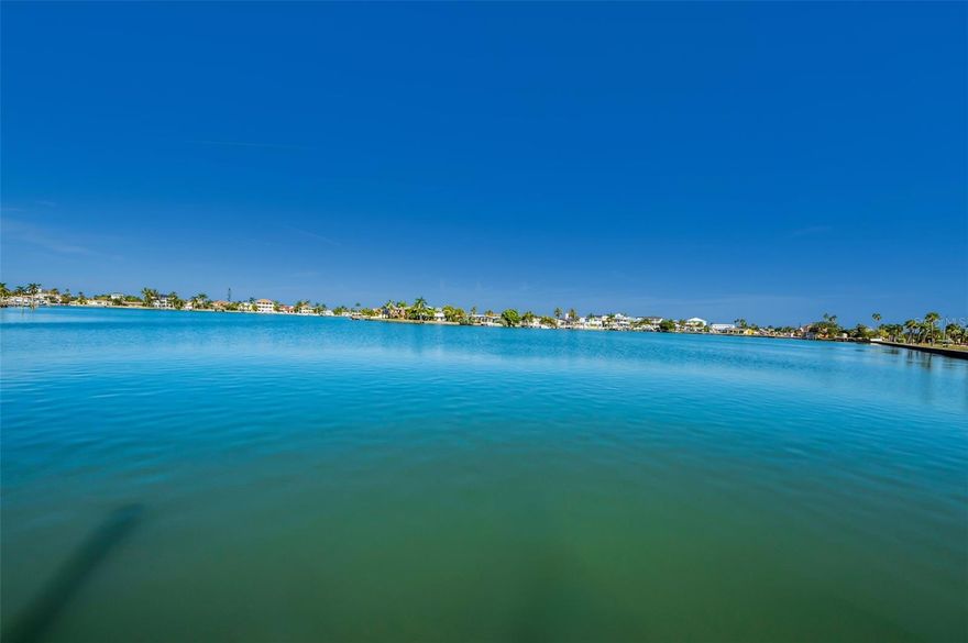 Discover the ultimate blend of serenity and coastal convenience in this deep-waterfront residence, perfectly positioned on a protected lagoon with 82 feet of direct water frontage and seamless access to the intracoastal waterways of Boca Ciega Bay.
Spanning 2,056 sq ft, this light-filled 4-bedroom, 2.5-bathroom home offers soaring 9.5-ft ceilings, an expansive open-concept layout, and breathtaking water views from the kitchen, living, and dining areas. A generous waterfront bonus room—currently ideal as a sunroom or home office—presents the flexibility to become a 5th bedroom. Hurricane-impact picture windows bathe the interiors in natural light while beautiful neutral terrazzo floors flow throughout.
Each of the bedrooms have generous windows for natural light.  The spacious primary bedroom with ensuite is situated down the hallway ensuring peace and quiet.  The second and third bedrooms allow for plenty of space for family and friends.  
A custom designed wood six bunk bed system has been carefully preserved and is ready to be set up in the third bedroom.  The expansive fourth bedroom has a wood burning fireplace for rest and relaxation.  
Step outside to your resort-style backyard: a spacious brick-paver patio framed by low-maintenance artificial turf and lush, mature landscaping creates an intimate outdoor living area. A hidden west-side sanctuary offers endless possibilities—a secret garden, zen retreat, shaded play area, or your own private oasis.  A composite dock features two slips, one with a boat lift, allowing you to be cruising the intracoastal waterways, the other with deep sail boat water.
A leisurely 3-block stroll brings you to the sugar-sand shores and sparkling waters of the Gulf, with exclusive resident-only parking at Redington Beach.  Other notable features: expansive brick paver drive, brand-new roof in 2025, 2013 seawall, flood gates, and whole home mahogany trim that has been salvaged and cleaned.  Home deemed NOT Substantially Damaged.