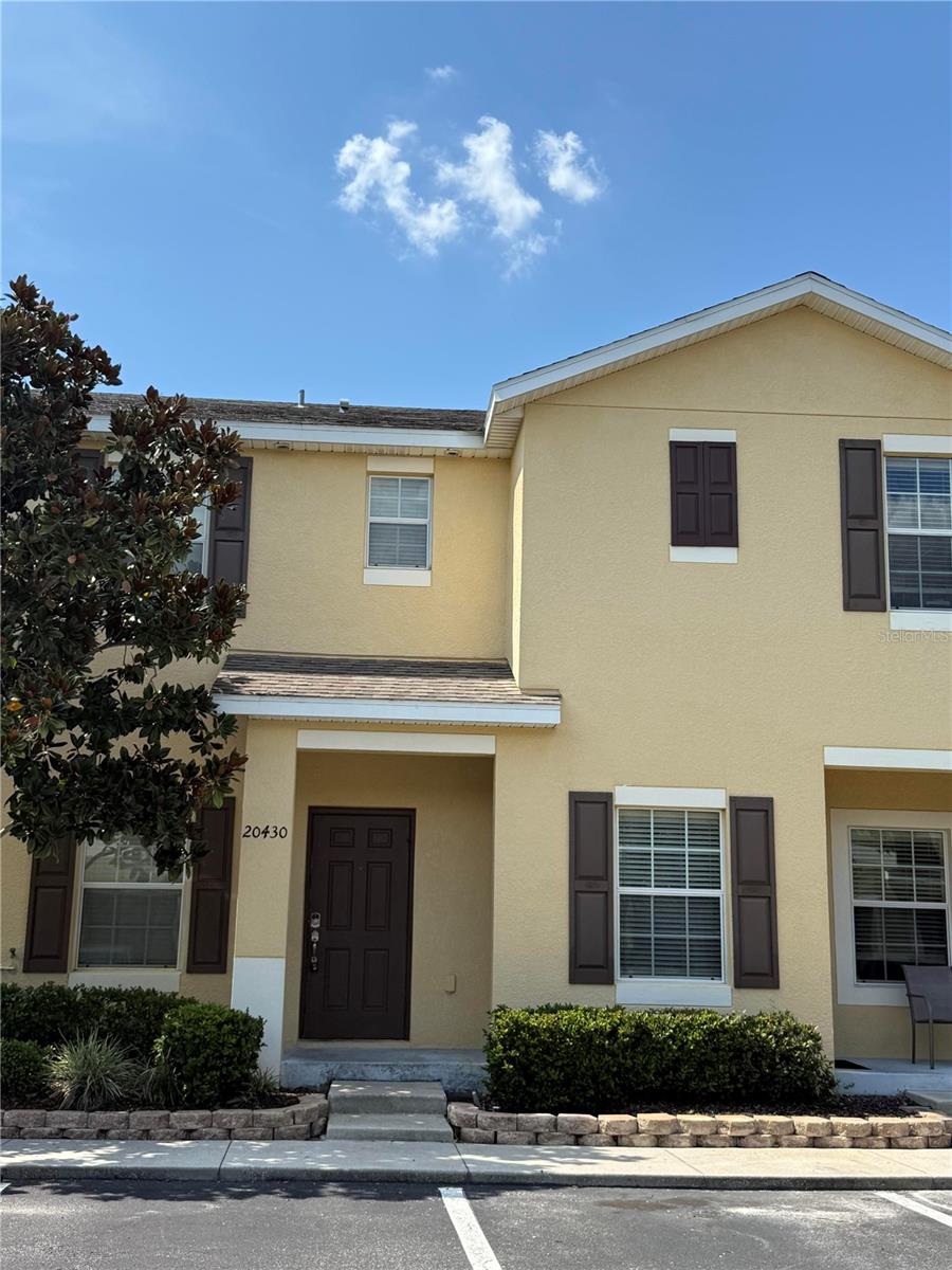 Move-in ready, clean and newly painted. This 2-bedroom, 2.5-bath townhome in the highly sought-after Hammocks gated community of New Tampa offers the perfect blend of style, comfort, and convenience. Step inside to find a welcoming front dinette area leading to a central kitchen with granite counters, stainless steel appliances, a large pantry, and a breakfast bar overlooking the spacious great room. Enjoy tile floors throughout the main level, a convenient half bath, and sliding doors that open to your private, fenced lanai, ideal for relaxing or entertaining. Upstairs, you'll love the fresh new carpet in the hall and stairs, plus newly installed LVP flooring in both bedrooms. Each bedroom features its own en-suite bath with walk-in shower, offering privacy and flexibility. The primary suite also includes a generous walk-in closet. Freshly painted interiors in soft, neutral tones create a warm and inviting atmosphere throughout. The Hammocks is a gated neighborhood known for its mature landscaping and resort - style amenities including a sparkling pool and fitness center. With an unbeatable New Tampa location , you'll be just minutes from top rated schools, Wiregrass Mall, Tampa Premium Outlets, USF, area hospitals, and quick access to I-75 and I 275 for an easy commute. Don't miss your chance to call this bright and happy home yours.