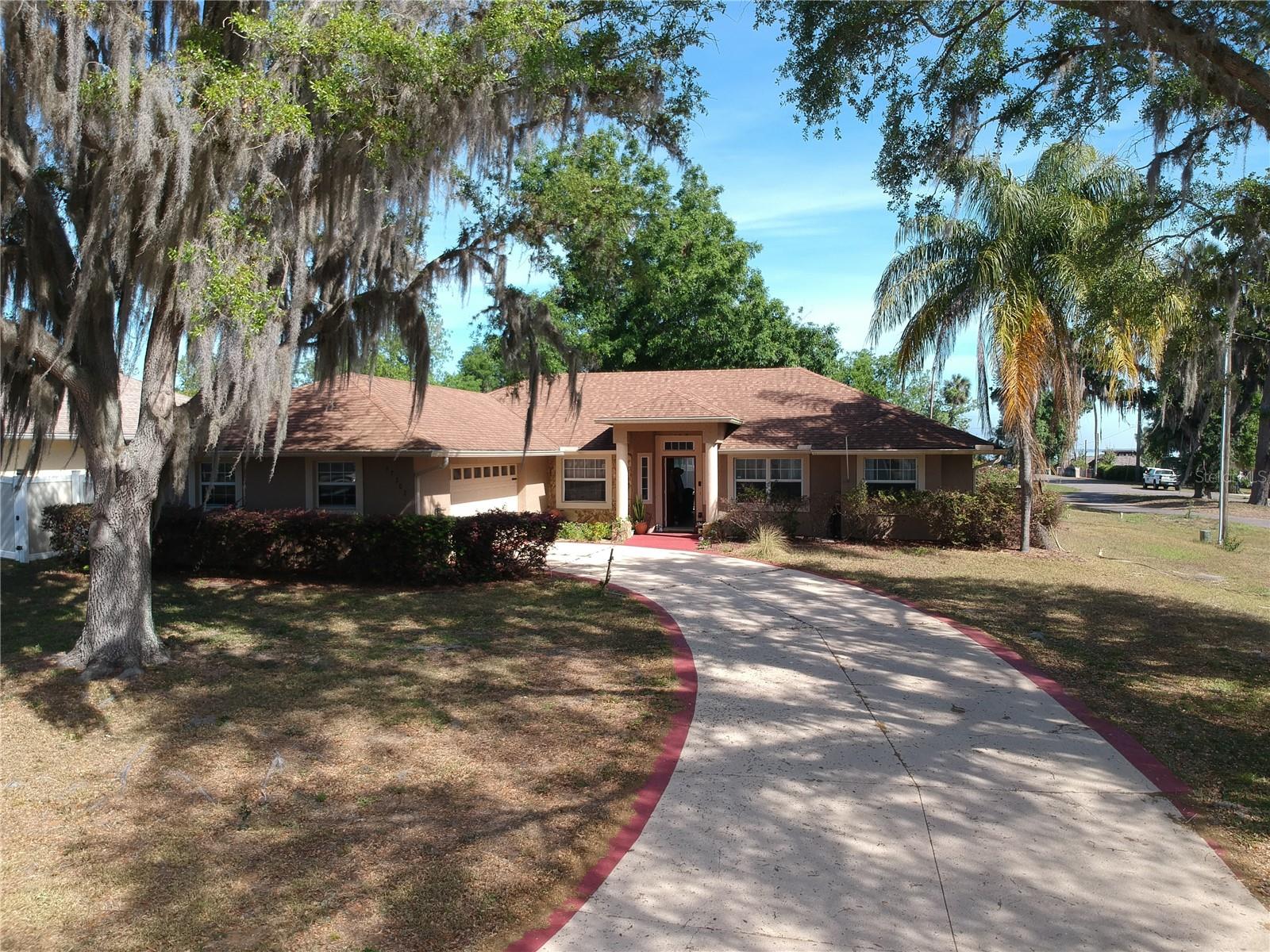 Welcome to 17302 2nd St, Montverde, FL 34756! This delightful home is conveniently located just a short distance from Montverde Academy and Apopka Lake, offering the perfect blend of education and outdoor enjoyment. Situated on a spacious corner lot, this property features a large, fully fenced yard—ideal for families and pets to play safely. With no HOA fees, you have the freedom to make this space your own. The inviting layout is perfect for both relaxing and entertaining, filled with natural light throughout. Embrace the friendly community atmosphere and all that Montverde has to offer. Don’t miss the opportunity to make this wonderful home yours!