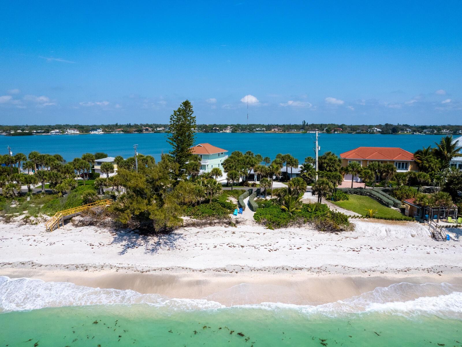 Build your dream home on this rare, half-acre gulf-to-bay property featuring approximately 98 feet of direct Gulf of America and Intracoastal Waterway frontage, complete with your private beach. A charming beach cottage offers a comfortable place to stay while you plan your custom estate. Existing dock with a 10,000-pound boat lift, installed in 2021, provides access to some of the deepest boating water in the area, ideal for all your water adventures. Bring your architect and builder to create a one-of-a-kind coastal retreat on one of Florida’s most exclusive barrier islands, where privacy, natural beauty and luxury living meet.