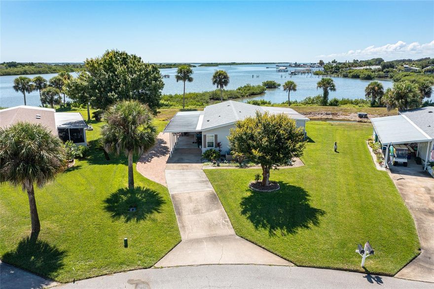 3 Bedroom 3 Bath WATERFRONT home with UNOBSTRUCTED VIEWS of the Indian River INTRACOASTAL Waterway.  A community DOCK is located just steps from the backyard where you can launch your canoe, kayak, paddleboard or even just catch a fish.  Entering this spacious home you will find a large great room with vinyl plank flooring, vaulted ceilings, and lots of natural light.  At the heart of the home is the kitchen with dark wood cabinetry, stainless appliances, granite counters, breakfast bar and pantry.  The bright and cheerful family room offers 5 glass sliders that open up to the deck and allow the river breeze to flow through the home.  An additional glass slider in the family room opens onto an enclosed porch where you can also enjoy breezes and views of the river.  The master suite has a double vanity sink, walk in shower and washer and dryer.  Another large bedroom is located off of the the great room with it's own bathroom and access to the enclosed porch.  Most of the home has been completely update including the roof and A/C in 2019, and the windows and doors in 2016.  Lighthouse Cove is a nice community with a clubhouse, pool, tennis courts, docks, boat launch, gated entry, and much more. ;Water: City