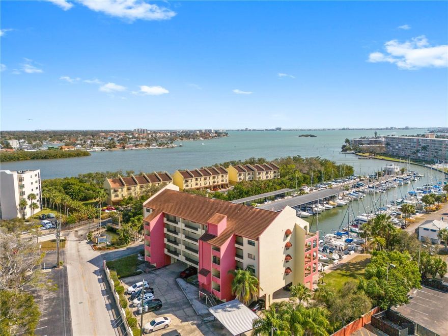 One or more photo(s) has been virtually staged. Begin your mornings to waterfront serenity and end your evenings with glowing Gulf Coast sunsets. Unit #202 at 1750 Harbor PL S  is a move-in ready 1 bedroom, 1.5 bath condo overlooking the tranquil marina and the natural beauty of the Boca Ciega Bay. Watch dolphins and manatees glide through the water while boats drift in and out, creating your own private front-row seat to Florida’s marine life. The open floor plan in the living area creates a seamless transition to your spacious private balcony. The balcony also provides hurricane shutters. The kitchen is updated with stainless steel appliances, new dishwasher/disposal, quartz counter tops, and breakfast bar. There is a full size washer and dryer in the unit and a tankless water heater. The bedroom has a walk-in closet and has an updated bathroom with oversized walk-in shower with floor-to-ceiling tile, frameless glass, & built-in bench.  This unit comes with one covered parking space and ample guest parking. The building has a brand new elevator that leads directly to the unit. The community itself offers a relaxed, well-maintained environment with a heated waterfront pool, clubhouse with kitchen, saunas, kayak storage, and a small launch area. Additionally, boat slips are available in the marina for separate fees (subject to availability). Condo fees include cable, internet, water, and trash. FLOOD INSURANCE NOT REQUIRED & THE ROOF SCHEDULED TO BE REPLACED THIS YEAR. Located minutes from St Pete beach, Treasure Island, and Sunset beach. Plus close to renowned waterfront restaurants, local shops, Pasadena Hospital, and the energy of downtown St. Petersburg. Whether you enjoy beach days, biking along the coast, trying new restaurants, or simply soaking in the scenery, everything is nearby. Come experience the marina views and coastal lifestyle in person. Schedule your private showing today.