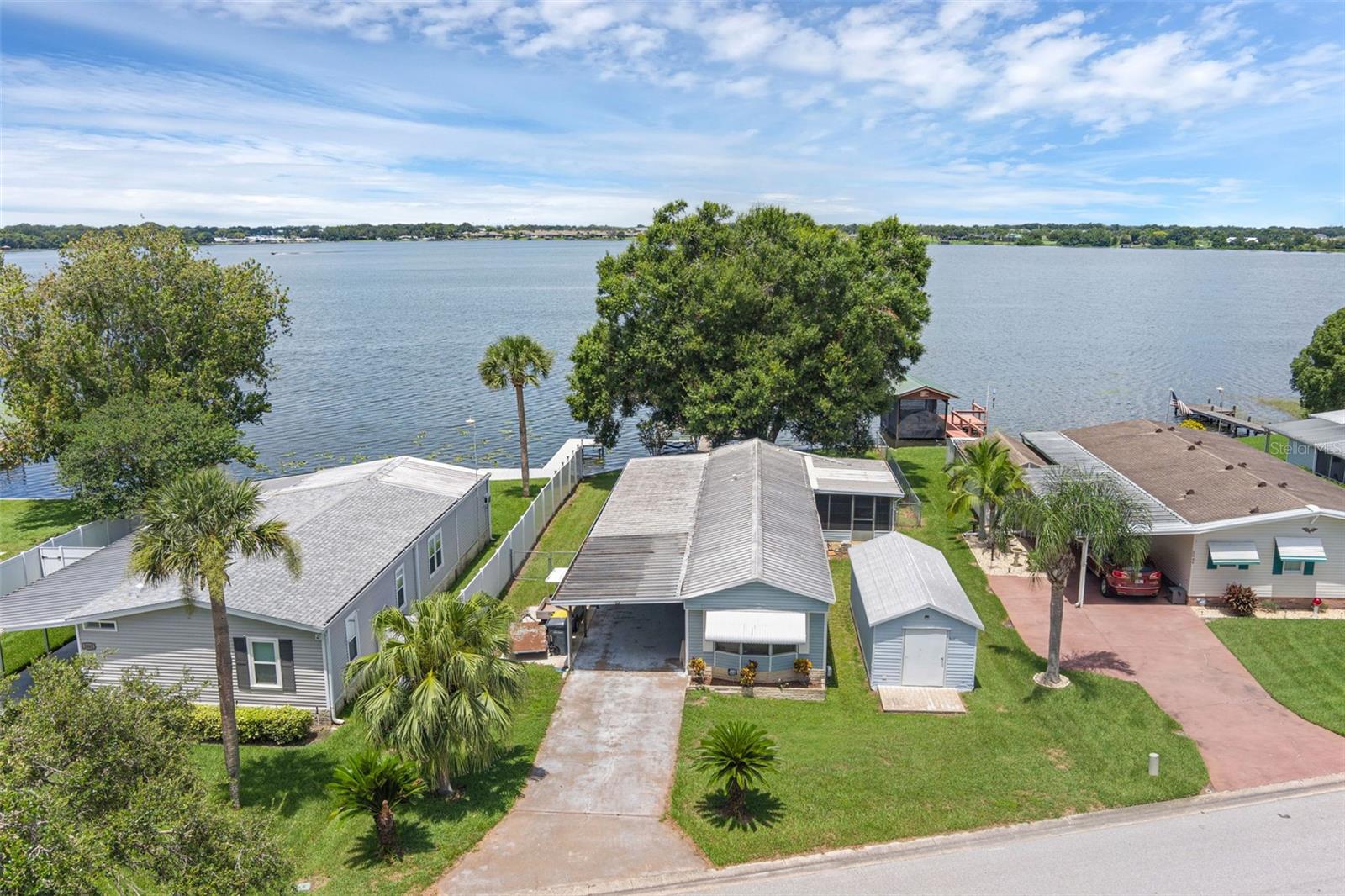 NEW PRICE! Picturesque lakefront property featuring over 60 feet of direct water frontage access. This 2-bedroom, 2-bath home offers updated flooring and refreshed bathrooms throughout. The split-bedroom layout offers privacy and a spacious finished Florida room and a screened porch provide ample space for relaxing or entertaining with stunning lake views.
A standout feature is the 10x24 metal shed, fully equipped with electric and air conditioning—perfect for hobbies, storage, or workshop use.
Exterior highlights include a metal seawall, private wooden fishing pier, boatlift, and access to a concrete boat ramp exclusive to community residents. Enjoy motorized and non motorized activities on Lake Mariana's 514 acre body of water.
Conveniently located just minutes from I-4 with easy access to Tampa, Orlando, Winter Haven Regional Airport, and major attractions.
Book your appointment today to view affordable lakefront living with updates, space, and endless possibilities!