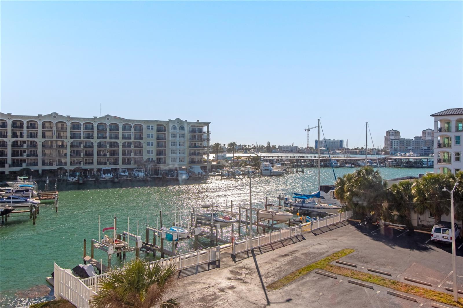 One or more photo(s) has been virtually staged. One or more photo(s) has been virtually staged. Corner unit with both bedrooms offering water views! Live the tropical beach lifestyle at Dolphin Point. Dolphin Point is a waterfront community that offers a waterside pool, dock, walk to Publix and cafes, and short walking/biking distance to the sugar sand of beautiful and exciting Clearwater Beach with all its restaurants, music, festivals, Pier 60, and so much more! Schedule a viewing today! Guest bedroom includes a built-it Murphy bed (can be removed if requested).