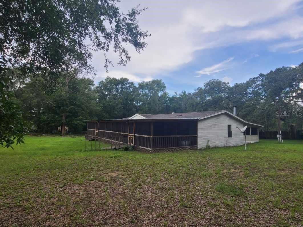 Here is your chance to own a 3 bed 2 bath 1998 manufactured home on 5.5 wooded acres away from it all, but be minutes to major hwys. Perfect for a commuter, traveling sales, or just wanting to get away from the traffic and the grind of daily life. Mfg.Homes boasts an impressive large screened covered front porch (which has wheelchair access), for spacious entertaining and wood burning stove in Family Room off kitchen and another covered screened back porch. The AC is only 2 years young. Appliances (Fridge, washer, dryer, dishwasher, stove) are included with no warranties. The large rustic wood horse barn and property can house your favorite furry friends or your favorite weekend toys: RV, Argo, dirt bikes, motorcycles, boat etc. and has water and electric. Wooded lot furnishes privacy and tranquility at its best. There are 2 wells and septic systems. Build your dream home or just expand the multi purpose uses of this property to your liking. Check with Hernando Co on specific uses and requirements for building a 2nd home. Homes entrance is off the beaten track and easement was granted from original entrance (which is still viable). Recent appraisal attached for review, so there is no question of the value. Call today for your private tour.