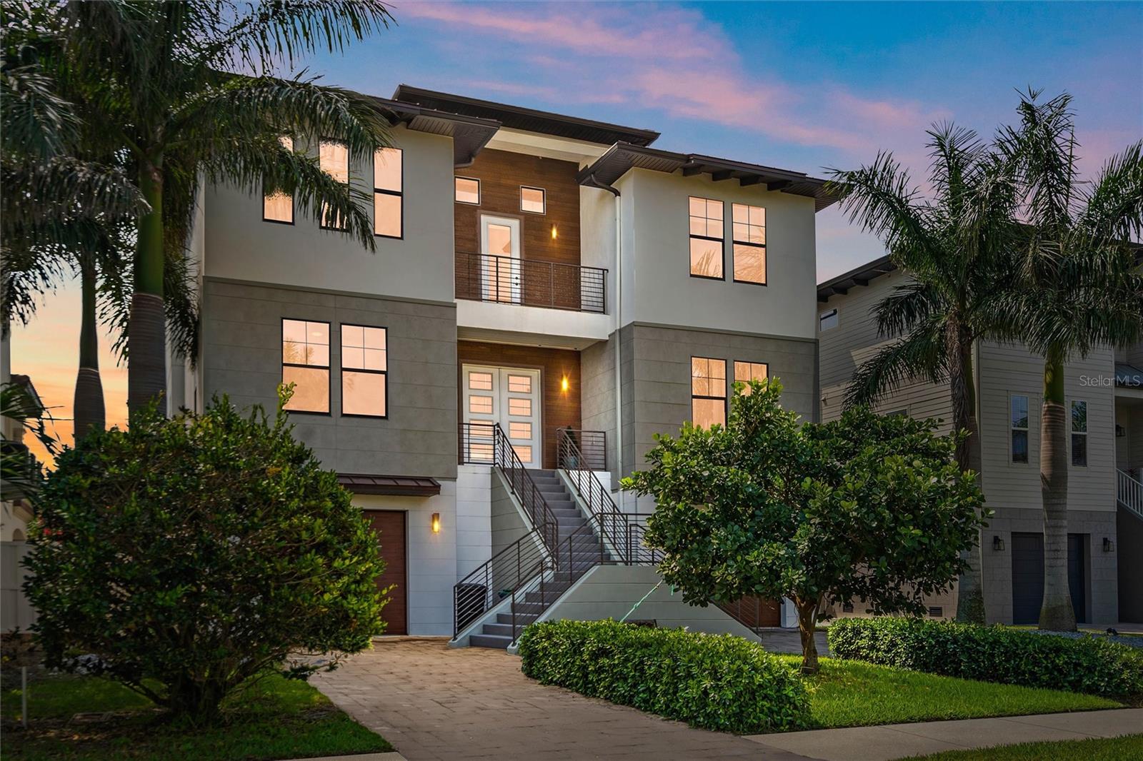 This exquisite custom-built coastal contemporary home features 4 bedrooms, 4 baths, and is situated in the prestigious Redington Shores Yacht and Tennis Club. This resort-style, guard-gated community is just steps away from the Gulf of Mexico and offers a range of amenities that set it apart from other communities in the area. These include 24-hour security, tennis courts, a clubhouse with a fitness center, a community spa, a pool, and a kayak/paddleboard launch, as well as a fishing dock. Built in 2016, this open-concept home boasts an abundance of natural light and luxurious finishes throughout, including European wood flooring and hurricane impact-rated windows and doors. An elevator provides convenient access to all floors. The expansive kitchen is perfect for entertaining, featuring high-end appliances, Italian cabinetry, and quartz counters. The main floor offers a spacious family room, a generous dining area, two bedrooms with walk-in closets, and two baths. A striking cable and wood staircase leads to a third-floor bonus room with breathtaking water views - ideal for a game room or can be made into an additional bedroom or in-law suite. The primary bedroom is well-appointed with a sitting area, his and her walk-in closets, a grand shower, floating cabinetry, and a soaking tub. The third floor also includes a fourth bedroom, a full bath, and a walk-in laundry room. You can enjoy indoor/outdoor living on the spacious balcony or terrace, which overlooks the heated saltwater pool and spa. The location of this home offers easy walking access to the beach, many restaurants, bars, shops and the Redington Village. Nearby is Tampa International Airport, Downtown St. Petersburg, pro sports stadiums, entertainment, museums and all of the BEST that Tampa Bay has to offer! Deeded docks with lifts are able to be purchased by residents when available.