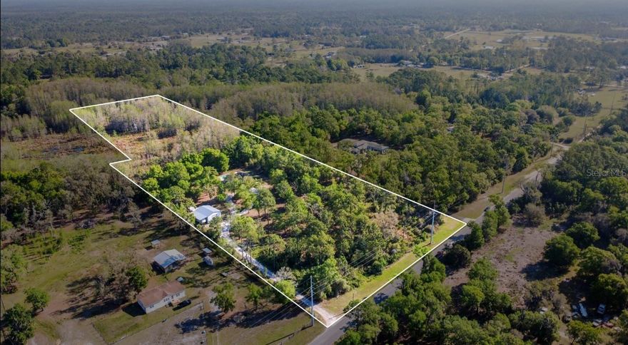 “These are the days” you have been waiting for.

2023 POOL HOME | 40' x 30' METAL SHOP | RV CARPORT WITH 50 amp RV HOOKUP | GORGEOUS ADU | 10 ACRES | OLD FLORIDA VIBES, AND JUST THE RIGHT AMOUNT OF COUNTRY LIVING TO MAKE YOU NEVER WANT TO LEAVE.

Built in 2023, this 4-bedroom, 2-bath home sits on a beautiful 10-acre property that truly gives you room to breathe. Step inside to a bright, welcoming living room with the kitchen tucked toward the back—keeping the space open while still feeling intentionally defined. The layout is thoughtfully split, with two bedrooms and a full bath just off the living room, while the dining area leads to the primary suite and an additional bedroom. An extra bonus is the partially insulated garage with AC unit, ready to be used as a flex room!

OUT BACK IS WHERE THIS PROPERTY REALLY BECOMES SOMETHING SPECIAL. An in-ground pool sets the stage for entertaining, relaxing, and everything in between—whether that means hosting friends, gathering around the fire pit, or simply enjoying the quiet.

AND THEN THERE IS THE VIEW—THE TRUE HIGHLIGHT. THE BACK FIVE ACRES OPEN UP TO A SERENE LAKE AND WETLAND SETTING, OFFERING A PEACEFUL, NATURAL BACKDROP THAT CAPTURES THE ESSENCE OF OLD FLORIDA AT ITS BEST. IT IS PRIVATE, CALMING, AND SOMETHING YOU WILL APPRECIATE EVERY SINGLE DAY.

The bonus features only add to the appeal. A fully equipped ADU offers 1 bedroom, 1 bath, its own kitchen, living space, and a wooden deck—ideal for guests, extended family, or rental income. Just beside it, a detached garage provides ample room for storage, equipment, or a workshop setup, along with an additional laundry space dedicated to the ADU. The attached RV carport makes it easy to bring all your toys and still have room to spare.

IF YOU HAVE BEEN SEARCHING FOR SOMETHING NEWER, WITH LAND, A POOL, FUNCTIONAL OUTBUILDINGS, AND A SETTING THAT FEELS LIKE A TRUE ESCAPE—THIS IS IT.