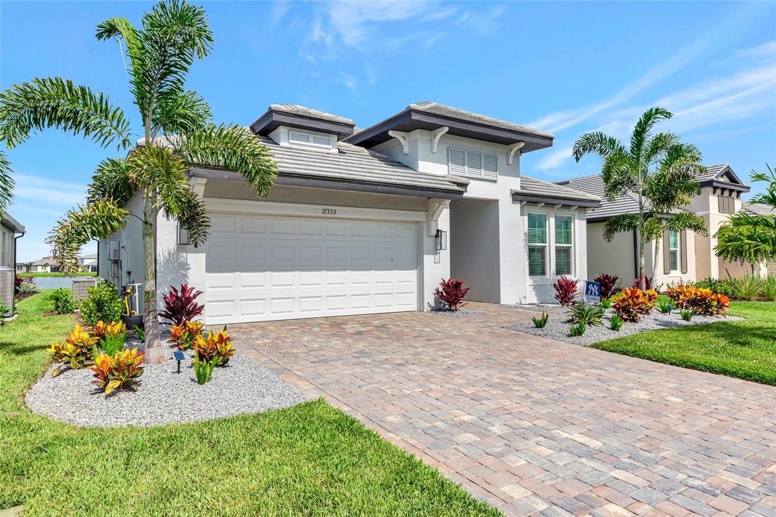 Step into luxury living with this fully customized Calusa model in the highly sought-after Sweetwater community of Lakewood Ranch—where premium design meets peaceful waterfront serenity. Built by M/I Homes and thoughtfully enhanced with over $117,000 in designer upgrades, this 4-bedroom, 3-bath home offers 2,195 square feet of elevated living.
From the moment you arrive, you’ll notice the striking curb appeal with Sierra-style paver driveway, tropical landscaping, and a sleek elevation enhanced by IMPACT-RATED windows—offering year-round hurricane protection without the hassle of shutters.
Highlights Include:
Gourmet Kitchen featuring a waterfall-edge quartz island (Level 4), designer backsplash in a herringbone pattern, upgraded Sonoma-painted cabinetry with crown and light rail, and GE Profile stainless gas appliances.
Owner’s Suite Retreat with a spa-like bath including Cambria quartz counters, frameless shower with upgraded black hardware, and a custom-built walk-in closet.
En-Suite Guest Room ideal for visitors or multigenerational living.
Custom Closets in the primary and guest bedroom, professionally installed post-closing.
Elegant Flooring throughout, including luxury vinyl plank in all bedrooms, great room, and kitchen, plus premium tile in bathrooms and laundry.
Designer Finishes like 5 ¼” crown molding in tray ceilings, upgraded matte black hardware, and high-end lighting and fan prewires.
Energy Efficiency & Convenience with a Rinnai tankless water heater, SmartShield structured wiring, and pre-plumbed outdoor kitchen rough-in.
Outdoor Oasis featuring a 14x27 extended lanai with tranquil water views—perfect for morning coffee or evening gatherings.
No more waterfront lots remain in Sweetwater. This is your rare opportunity to own one of the community’s most desirable homesites—without the wait to build.
Additional perks: Impact-rated sliders, upgraded 8’ doors, quartz in all baths and laundry, upgraded rain shower head, epoxy-coated garage floor, and full appliance package including front-load washer/dryer and French door refrigerator.
Located in the heart of Lakewood Ranch with access to resort-style amenities, scenic walking trails, and top-rated schools—this home is the total package. The owners also contracted to have a custom pool and outdoor kitchen installed so no need to wait if you want to move forward with them. Pool design and renderings avaiable.