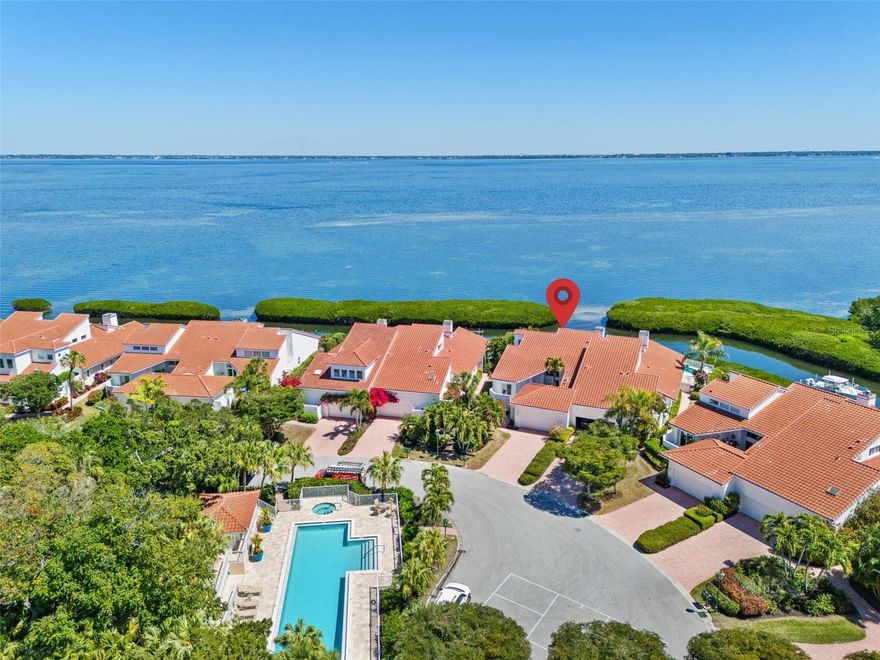 Nestled behind the gates of Bay Isles on Longboat Key, this exquisite residence offers a rare blend of elegance and tranquility. Boasting full bayfront views, this home welcomes you with a sense of serenity and coastal charm. Upon entry, you are greeted by an inviting living space, adorned with natural light streaming through expansive windows that frame the breathtaking waterfront panorama. The open-concept layout with elegant fireplace, seamlessly transitions into a gourmet kitchen, featuring modern appliances, sleek countertops, and ample storage space. Dine in style in the large dining area, beautifully illuminated by a chandelier suspended from the cathedral ceiling. A gracious den provides additional space for reading, working or watching television. The main level hosts two well-appointed en-suite bedrooms, each offering a peaceful retreat with generous closet space The owner’s suite provides breathtaking views of Sarasota Bay A beautifully appointed bathroom provides a spa-like experience, complete with a luxurious soaking tub, separate shower and ample closet space. Ascend the stairs to discover a large loft bedroom, offering versatility, privacy, and views of the water. This airy space can be used as a guest suite, home office, or a relaxing entertainment area, providing endless possibilities to suit your lifestyle. Step outside onto the lovely outdoor terrace, where you can savor your morning coffee or unwind with a glass of wine while soaking in the mesmerizing bayfront vistas. For the nautical enthusiasts, the private dock can accommodate your boat up to 32’ Residents of Harbour Court enjoy a world of resort style amenities, plus all the benefits of the private Bay Isles Beach Club. Longboat Key Club membership is available for an additional fee, but not required. It offers 45 holes of golf, tennis, pickleball, a marina, and 5 restaurants, plus access to many events and additional amenities. Stunning views in this spacious Direct Bayfront home in Harbour Court, an intimate, well maintained community of just 18 luxury residences.