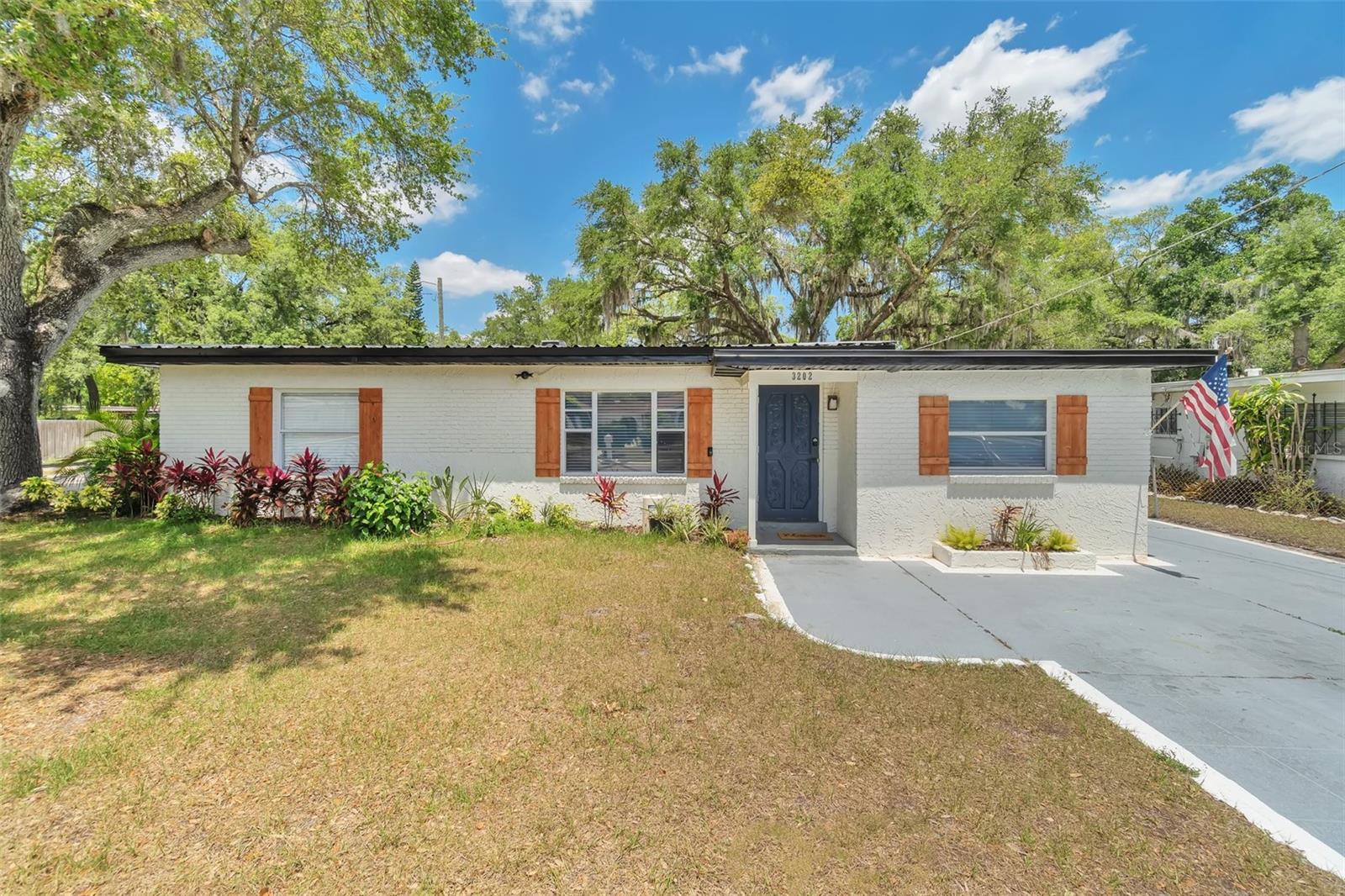 Welcome to 3202 E Jean Street| Your Move-In Ready Corner Lot Retreat! This beautifully updated 3-bedroom, 2-bath home features a 2025 flat roof, 2017 metal roof, and a 2024 tankless water heater for long-term peace of mind. Enjoy luxury vinyl plank flooring throughout and a bright, open layout perfect for modern living. The updated kitchen includes shaker-style cabinets, granite countertops, and stainless steel appliances. The primary suite features a private en-suite bath and ample closet space. Two additional bedrooms and a guest bath offer flexibility for family or guests. Large indoor laundry room and fully fenced yard provide comfort and convenience. Located near USF, Busch Gardens, Hard Rock Casino, and major highways (I-4 & I-275). No HOA—bring your boat, RV, or make it your own! KEY FEATURES: Newer Roofs (Metal + Flat) | Tankless Water Heater (2024) | Corner Lot with Fenced Yard | Updated Kitchen & Baths | No HOA or CDD | Minutes from USF, Busch Gardens, Moffitt Cancer Center, Ybor, Hard Rock Casino, I-4 & I-275 Highways | Located in a revitalized and growing part of Tampa. Don’t miss this opportunity—schedule your showing today!