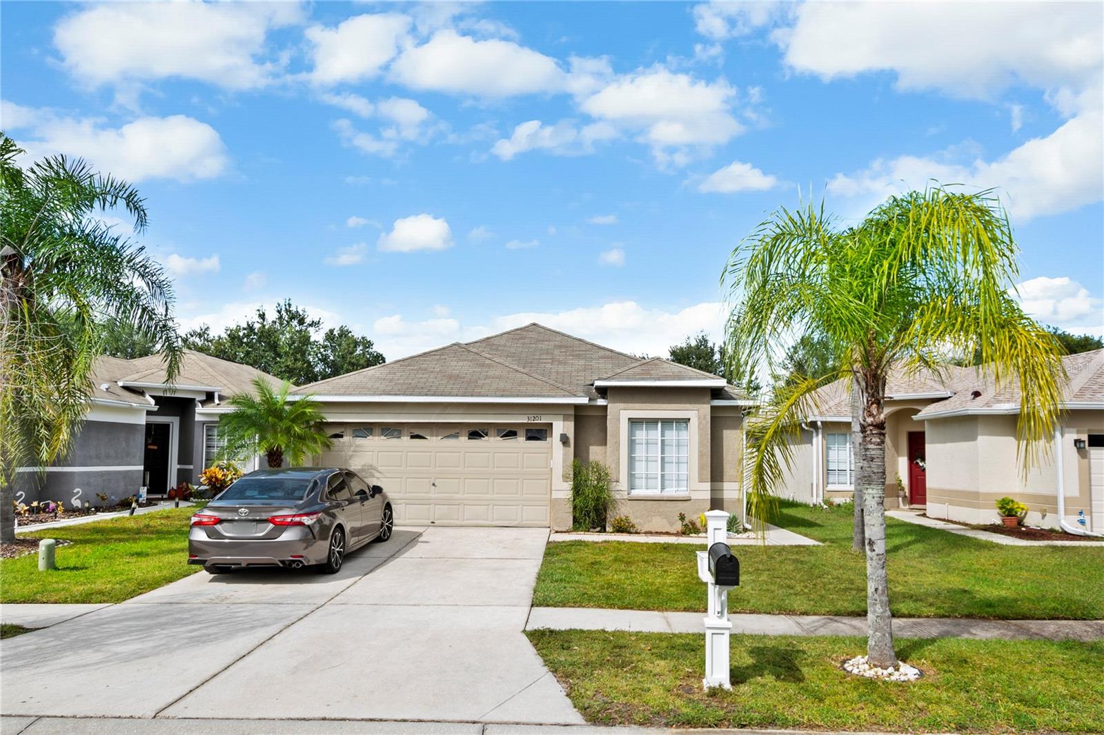 Bring all offers! Seller will replace roof before closing with an acceptable offer! Welcome Home to 31201 Tagus Loop! New to the market 4 Bedroom, 2 Full Bathroom, 2 Car Garage Home! Located in Wesley Chapel built in 2005 with a newer 2018 AC! Open Floorplan, with Vaulted ceilings, & Wood and Tile flooring throughout. Primary Bedroom features a spacious En-Suite Bathroom with Large Soaking Tub! Indoor laundry area, Bright lighting throughout, and a Dinette area attached to the kitchen! Beautifully landscaped with curb appeal, & a spacious fully-fenced backyard! Centrally Located to everything beautiful Wesley Chapel has to offer, just minutes from popular attractions such as parks, entertainment, and shopping! Minutes from The Grove Shopping Mall and Parks such as Bridgewater Community Park & Wesley Chapel District Park complete with walking trails, a community garden, sports fields, and plenty of playgrounds! Just 8 minutes from the famous Epperson Lagoon; 7 Acres of Clear Blue Waters and water activities fun for all ages! Reach out to an agent today for more information or a private showing!