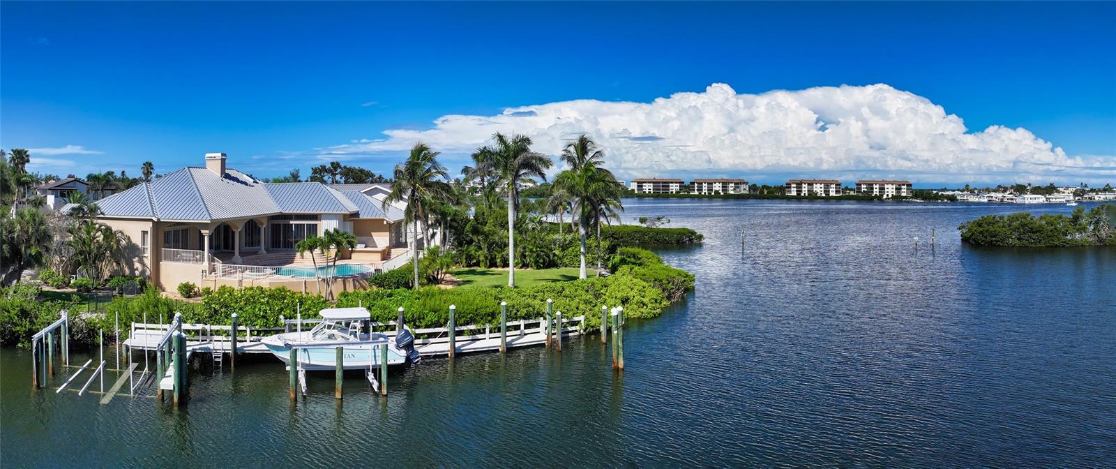 One or more photo(s) has been virtually staged. Spectacular Waterfront Estate in Bay Isles | Longboat Key
Rarely does a property of this caliber come to market. Located behind the exclusive, 24-hour guarded gates of the Longboat Key Club in the prestigious Bay Isles community, this estate spans 4,200 square feet of elegant one level living space. With 5 spacious bedrooms, 4.5 baths, plus a dedicated office—all under soaring 12-foot ceilings—this home offers refined luxury with an unmatched sense of openness and light.
Set on one of the largest lots in Bay Isles at just under 20,000 square feet, this peninsula-shaped property boasts 205 feet of prime water frontage and breathtaking, unobstructed views over Buttonwood Harbor. Enjoy the ultimate boating lifestyle with three boat lifts situated along a deep-water, wide canal on the protected north side of the property.
Built with solid block construction, the home sits high and dry with an impressive 4,000-square-foot elevated lower level—ideal for the serious car collector, with the capacity to accommodate over 10 vehicles. Currently utilized as a high-end fitness facility, this space offers endless flexibility.
The recently updated chef’s kitchen is a dream for culinary enthusiasts, featuring top-of-the-line gourmet appliances, a massive center island, and rich solid wood cabinetry. Outdoors, the magic truly begins—an expansive terrace surrounds the oversized pool, perfectly positioned to take in panoramic views of the harbor. Entertain effortlessly with a outdoor kitchen and multiple lounging areas that make the most of this remarkable waterfront setting.
Additional recent upgrades include a brand-new standing seam metal roof (2024), ensuring peace of mind and long-term durability.
Residents of Bay Isles enjoy exclusive access to the private Bay Isles Beach Club and its pristine Gulf-front beach, as well as the convenience of on-site amenities including Publix, CVS, banking, dry cleaning, and more.
This is more than a home—it’s a once-in-a-lifetime opportunity to own one of the most coveted properties in Bay Isles. Don’t miss your chance to make this exceptional estate your own.