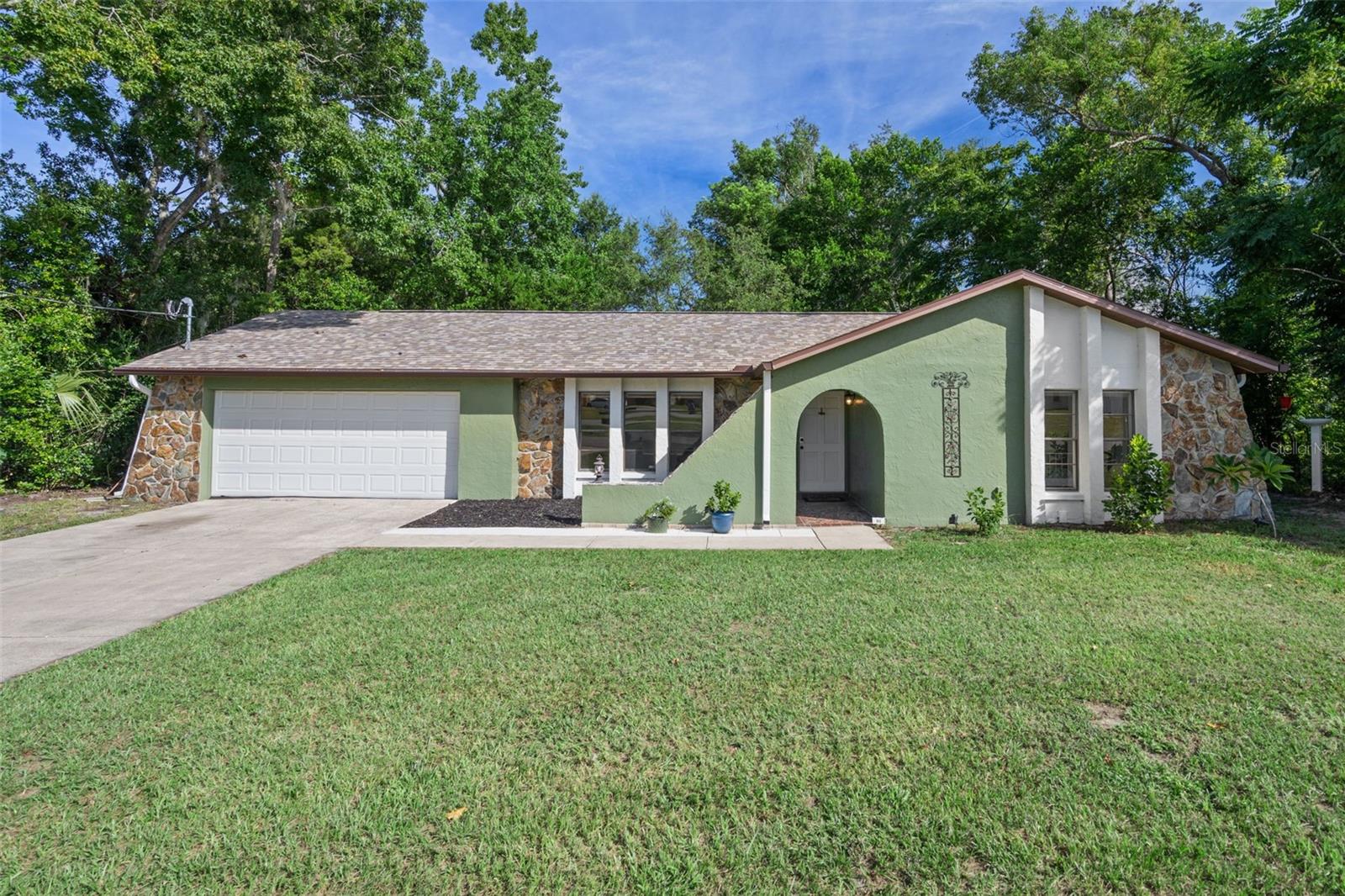 Discover the perfect blend of comfort and charm in this beautifully kept 2-bedroom, 2-bathroom home with a 2-car garage, tucked away in a peaceful, sought-after community. Step outside to your own private oasis. A spacious backyard framed by mature trees, offers both shade and serenity. A vinyl privacy fence provides privacy, but also is gated and opens to sweeping views of Hunter Lake. Imagine enjoying morning coffee with tranquil water views or evening gatherings surrounded by nature. Inside, the home flows with a welcoming and comfortable layout, designed for both relaxation and everyday living. The primary suite provides a peaceful retreat with its own private bath, while the second bedroom and full guest bath offer comfort for family or visitors. Large windows throughout allow natural light to fill the home and highlight the serene surroundings. With its combination of charm, natural beauty, and peaceful surroundings, this home offers a lifestyle that is hard to find and even harder to forget.