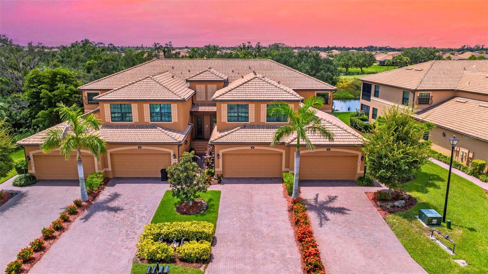 Live the Ultimate Florida Golf & Coastal Lifestyle! Perched above the lush greens of River Strand Golf & Country Club located within the Heritage Harbour gated community, this beautiful 3-bedroom, 2-bath upper-level coach home offers a rare combination of panoramic golf, lake, and sunset views that will take your breath away. Imagine relaxing on your private screened lanai as the sun dips below the horizon, with a front-row seat to the pristine Pro Tee box and the shimmering waters beyond. Inside, you’ll find 2,108 sqft of light-filled, open-concept living space designed for comfort and style. The spacious kitchen features granite countertops, stainless steel appliances, solid wood cabinetry, and a charming breakfast nook framed by a bay window, which is perfect for enjoying morning coffee while watching wildlife on the lake. The expansive living and dining areas flow seamlessly to the lanai, creating an entertainer’s dream. The owner’s suite is a peaceful retreat with sliding doors to the lanai, two walk-in closets, and a spa-like bath with dual vanities, soaking tub, and a separate tile shower. Two additional bedrooms, privately tucked away, have flexible space that can be used for guests, a home office, or hobby room. The home also includes a laundry room, lots of closets and an oversized 2-car garage with extra climate-controlled storage that is ideal for a golf cart, workshop, or seasonal items. This beautiful maintenance free Home comes with a coveted Social Membership, granting you access to Resort-Style Amenities such as a clubhouse with multiple dining venues, a tiki bar, a state-of-the-art fitness center, resort and resistance pools, tennis, pickleball, and much more. And when you’re ready for a change of scenery, you’re just minutes from the beautiful sugar-sand Gulf Coast Beaches of Anna Maria Island and Siesta Key, vibrant dining options, boutique shopping, and year-round events. Whether you’re seeking a full-time residence, a seasonal getaway, or a snowbird retreat, this home delivers the best of coastal living, championship golf, and carefree luxury. Schedule your private tour today. Amazing homes like this don’t last long!