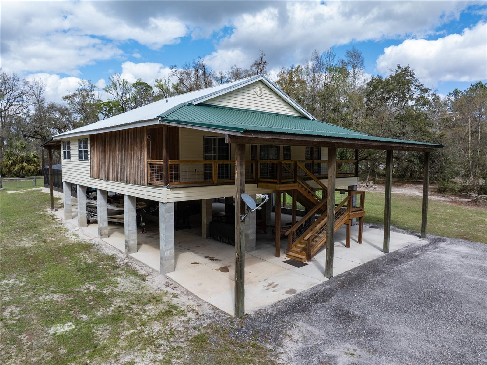 Nestled on the banks of the picturesque Suwannee River in Branford, FL, this stunning 3-bedroom, 2-bathroom home offers the perfect blend of comfort and adventure. Currently operating as a successful Airbnb, this income-producing property can be a turn-key investment & a scenic getaway. Upon entering, you are greeted by a spacious living area adorned with a charming gas fireplace and walls featuring beautiful cypress tongue and groove detailing, adding warmth and character. The home boasts covered porches both at the front and back, inviting you to relax and enjoy the breathtaking river views. One of the standout features of this property is its enclosed inground saltwater pool with a spa, ensuring year-round enjoyment and relaxation. Adjacent to the pool area, a convenient half-bath bathhouse adds to the ease and comfort of outdoor living. For those who love outdoor entertaining, a covered pavilion overlooking the river awaits, complete with a fish cleaning station nearby—perfect for preparing your fresh catch after a day on the water. A floating dock provides easy access for boating enthusiasts, making it effortless to explore the Suwannee River’s natural beauty. Inside, practicality meets convenience with amenities, including an elevator and a whole-house generator, ensuring ease of access and peace of mind for residents and guests alike. Whether you're looking for a peaceful riverside retreat, an income-producing investment, or both, this property has it!