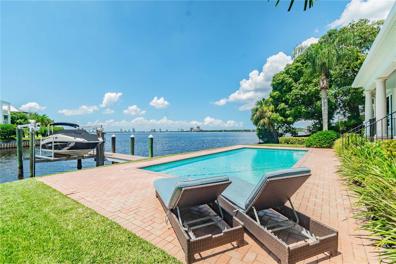 Rarely available! Hillsborough Bay waterfront property with an easy walk to all the restaurants, shops and amenities that make Davis Islands unique. This 4 bedroom, 4 bath, bayfront Mediterranean home (with pool) was custom built in 2000 on over a quarter acre with 100 feet of waterfront with a boat lift. It has breathtaking bay views from almost every room. This home features an open floor plan with 4,071 heated sq. ft. of luxury living. The open kitchen features Viking appliances, natural gas cooking, tons of storage and granite countertops. The first floor features both formal and informal dining areas, a gas fireplace and opens onto a covered terrace for outdoor living. The first floor also includes a guest retreat with a private bath, lots of natural light, and remarkable bay views. The second floor features the primary bedroom, en-suite bath, a loft office area, and two additional bedrooms with bath. The primary bedroom features incredible bay views, and you can enjoy fabulous sunsets from the rooftop balcony. The primary bath features a walk-in shower as well as a separate make-up area. The home has a three-car garage and a paver driveway. The waterfront in-ground pool is the perfect place to spend an afternoon after touring Hillsborough Bay and River on your boat.