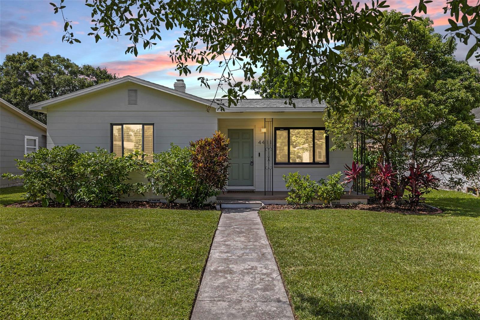One or more photo(s) has been virtually staged. Renovated and full of charm, this beautifully updated 2-bedroom, 1-bath home is centrally located in a NON-FLOOD ZONE in St. Petersburg! Inside, the home features restored original hardwood flooring, stunning tile, and a thoughtfully designed layout. The fully remodeled kitchen includes quartz countertops, custom cabinetry, under-cabinet lighting, and new lighting fixtures. The built-in dishwasher and microwave offer convenience and style - the perfect blend for a kitchen. The bathroom has been completely updated with marble hexagon tile, a frameless glass shower, new vanity, and contemporary fixtures for a fresh, spa-like feel. Extensive mechanical upgrades have been completed, including a new electric panel (2023), new main power wiring, several impact-resistant windows, new insulation in the attic (2025), epoxy flooring in the garage and front patio, and a wall-mounted garage door opener. The home also features a 2021 roof and 2019 HVAC, so it is move-in ready. Fresh interior and exterior paint, refinished drywall, updated landscaping, and a new backyard fence (2023) are just the icing on the cake! The cobblestone back patio creates a relaxing outdoor space where you can soak in your spacious yard. This home is zoned to allow for an ADU, giving you the rare opportunity for expansion, income potential, or multi-generational living. Located close to downtown St. Petersburg, I-275, and the Gulf beaches, this home combines charming character, modern upgrades, and is in a NON-FLOOD ZONE. Don’t miss out on this chance - schedule your showing today!