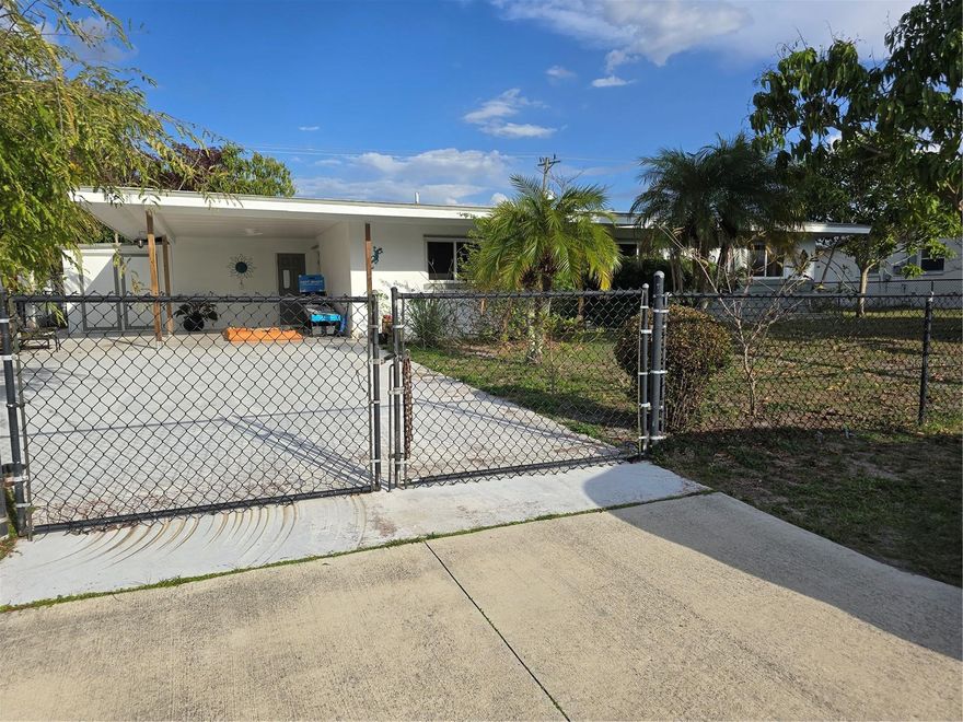 SPACIOUS HOME CONVENIENTLY LOCATED in the heart of Port Charlotte, close to schools, shopping, medical, recreational activities, the beautiful  HARBOR WITH A BEAUTIFUL SANDY WHITE BEACH, and spectacular sunsets. For those of you who like baseball, the TAMPA BAY RAYS' SPRING TRAINING is within 10 miles. World-renowned BEACHES ARE WITHIN 25-30 MILES, and there is so much more to see. The neighborhood is quiet and well-maintained. The interior of the home is well-kept and in good condition, but it can use a little updating. It features spacious living in over 1400 sq. ft. of space, in addition to a lanai. The front yard is primarily paved for easy maintenance and vehicle entrance and features a chain link fence with a wide gate for vehicle entrance to the carport, security, and privacy. The yard is perfect if you have a dog or a pet.  Relax in the lovely lanai and backyard with mature fruit trees and plants. This home offers many great features, and it is perfect for a first-time home buyer or investor, and just needs a little work to make it your own. Come and see for yourself the many poterntials of this home.