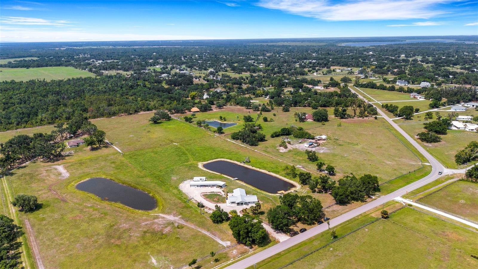 ** YOUR PRIVATE RETREAT WITH SWEEPING LAKE VIEWS, AN ARTIST’S STUDIO, AND ULTIMATE PRIVACY – WITH NO HOA! **
This one-of-a-kind country haven blends peaceful living with affordable luxury. Thoughtfully upgraded throughout, it checks every box for today's smart buyer: metal roof, impact-rated hurricane windows, a buried propane tank fueling a whole-house generator and tankless water heater, and a TRULY UNBEATABLE LOCATION—just minutes from town but worlds away in feel. The updated kitchen and bathrooms shine with quality finishes, and light pours through windows at every turn. Completely move-in ready, this home is a rare opportunity in an equally rare setting.
** HOME FEATURES:
IMPACT-RATED WINDOWS * Sleek, Modern Style * MASSIVE STORAGE, QUARTZ COUNTERS, and a HIGH-END THERMADOR PROPANE RANGE in the TWO-TONED DESIGNER KITCHEN * Walk-in Pantry with Roll-Out Shelves * TWO En-Suite Primary Bedrooms * Screened Porch * Barn Converted to Artist’s Studio Overlooking the Lake (Easily Reverts to Horse Barn) * Detached One-Car Garage * Oversized Screened Porch * TWO FISHING PIERS on a LARGE, PRIVATE LAKE * LUSH PASTURE GRASS – ideal for horses or livestock * Tankless LP Water Heater * Buried Propane Tank * WHOLE-HOUSE GENERATOR **
** COMMUNITY INFORMATION:
This stunning property sits DIRECTLY NEXT TO, but NOT INSIDE, Myakka Valley Ranches—offering all the perks of Sarasota’s most horse-friendly community with ZERO HOA or deed restrictions. Ride out on 30+ miles of scenic horse trails, wave to wonderful neighbors, and enjoy the freedom of rural living on your terms. Bordered by Myakka State Park, the area is rich with wildlife—deer, eagles, bobcats, and rare birds are regular guests. And thanks to the state park’s legal protections, your serene lifestyle is shielded from creeping development.