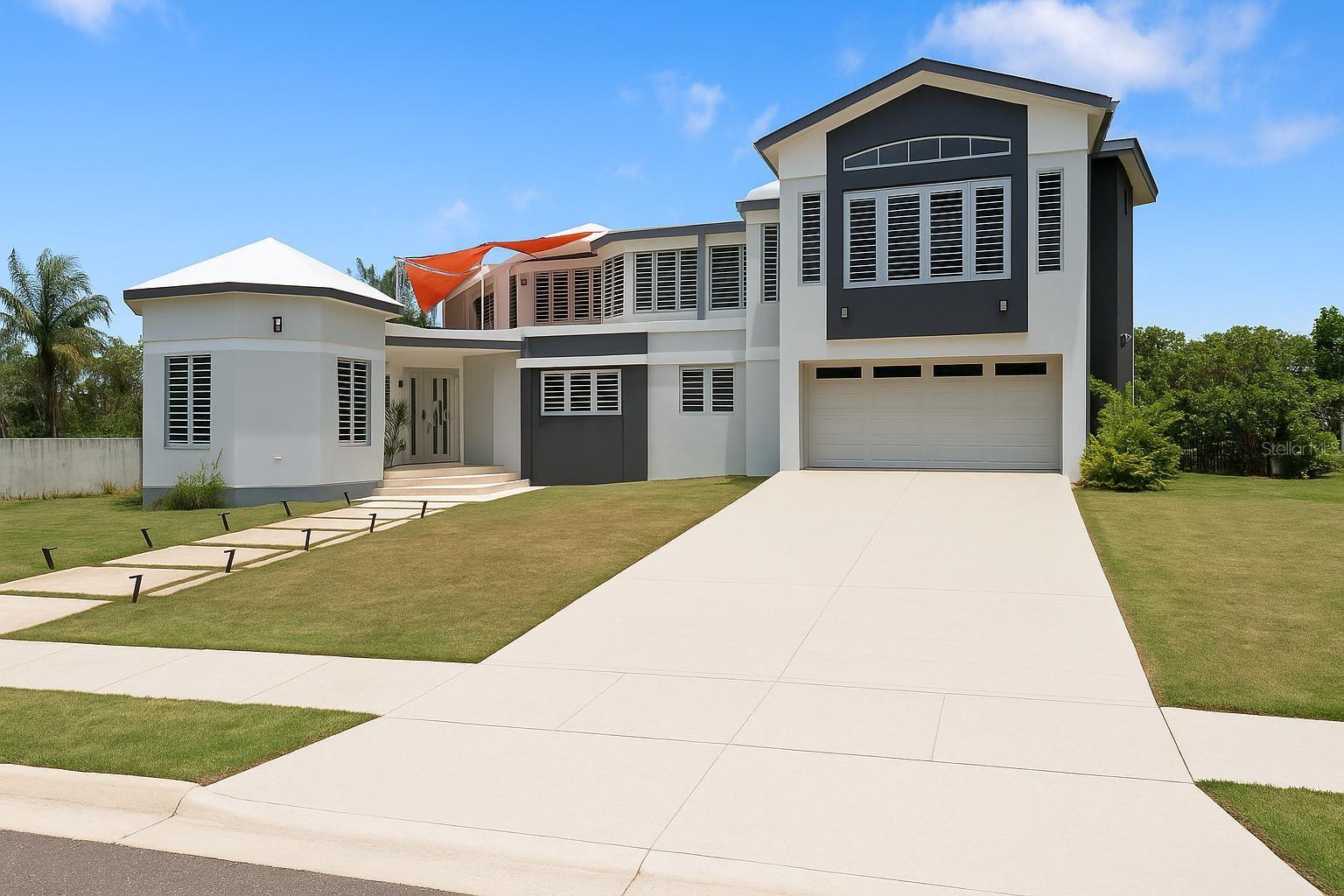 Indulge in elegance with this stunning two-story estate nestled in Isabela, PR. This distinguished residence redefines luxury living, offering over 6,500 square feet of refined interior space, meticulously designed for comfort, functionality, and timeless style — all situated on a sprawling 1,681 m² lot.
As you arrive, the commanding facade and grand driveway framed by green space immediately signal that this is no ordinary home. Step inside and be greeted by an impressive two-story foyer that opens into a series of carefully curated living spaces bathed in natural light and adorned with polished marble floors, soaring ceilings, and custom architectural finishes.
The heart of the home is the gourmet chef’s kitchen, where rich wood cabinetry meets modern design. It features quartz countertops, a large island with built-in cooktop, double wall ovens, and elegant glass tile backsplash. Adjacent is a cozy breakfast nook and a formal dining room perfect for hosting refined dinner parties. A built-in bar area offers the ultimate in entertaining convenience.
This residence boasts four spacious bedrooms all located on the main level, including a master suite that rivals a five-star retreat. The suite features vaulted ceilings, a designer ensuite bath, and a massive walk-in closet with custom cabinetry. Two of the secondary bedrooms share a Jack-and-Jill bathroom, while an additional full guest bathroom adds convenience and flexibility.
Ascend the stylish staircase to the second floor, where you’ll discover an expansive open-concept living area, perfect for a home theater, gym, or additional entertainment lounge. Also on this level is a office space, two sun-drenched terraces, and a chic half bathroom, ideal for guests.
Additional highlights include:
Solar panels for energy efficiency
Full laundry room with ample storage
Two-car garage with interior access
Multiple zones of living and lounging space
Space to build a custom pool, adding even more luxury potential
Located just minutes from Isabela’s famed beaches, shops, and dining, this home merges tranquil residential living with proximity to all modern conveniences. With its fusion of classic architecture and modern features, this estate is reserved for those with the most discerning tastes.
