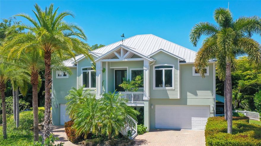 $75,000 price improvement!  Welcome to your dream home ~ This magnificent waterfront property offers nearly 4,000 square feet of curated living space.  Situated on .48 acres at the end of a cul-de-sac, the property includes a boat dock with lift and is in a prime location on Phillippi Creek, with access to the gulf and bay.  The luxurious 4-bedroom custom home is open concept for the designer kitchen and main living space, and also includes a movie theater, office, den and game room.  The home was recently luxuriously renovated, and 2023 upgrades include a new warming drawer, water heater, pool heater, jet pump, pool pump, wine refrigerator, grill and propane tank. Experience seamless indoor/ outdoor living with sliding door panels which open to an expansive lanai.  The outdoor kitchen seats 8 and overlooks a waterfall and lush grounds with water views.  The 3 car garage is an ideal 2/1 split with charging station.   The home has a back up generator and is ideally close to A-rated schools, a quick 10 minute drive to Siesta Key and just 4 miles to vibrant downtown.  Don't miss your chance to make this extraordinary residence your own!