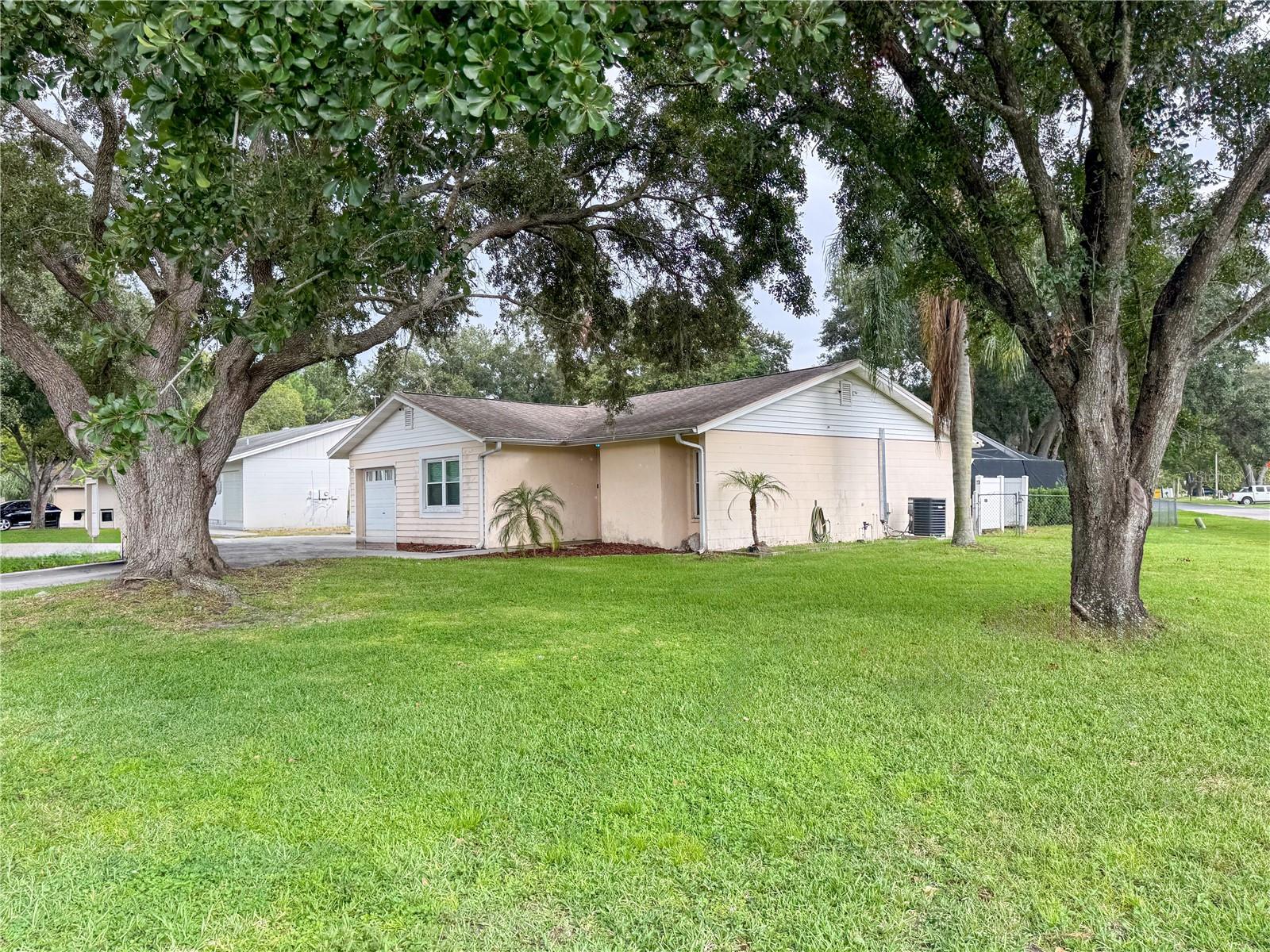 Welcome to this inviting three-bedroom, two-bathroom home on a large corner lot! Designed with a split bedroom layout, this open-concept residence is ideal for families or anyone seeking a bit of extra space. As you step inside, you’ll find a welcoming entryway with tile flooring that leads into the spacious living and dining areas, both featuring cozy carpeting. The kitchen is conveniently positioned for easy access, featuring granite countertops and stainless steel appliances making meal prep and family gatherings a breeze. Step outside to enjoy your very own screened-in pool, perfect for warm afternoons and weekend hangouts. The large corner lot offers a fenced yard, ideal for kids and pets to play freely. Safety and peace of mind come standard with a camera security system, allowing you to relax knowing your home is well-protected. Location is everything! You’ll love being directly across from the community park, which features a playground for the little ones and a peaceful shared pond, where you can enjoy catch-and-release fishing at your leisure. This home is a fantastic opportunity to settle in a friendly neighborhood with plenty of outdoor activities right at your doorstep. Don’t miss out—reach out today to schedule a visit and see the potential this property has to offer!