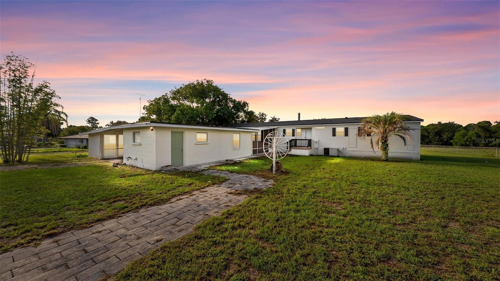Lakefront Living on 1.3 Acres! Move-in ready home with Detached In-Law Suite! Don’t miss this rare opportunity to own a beautifully maintained manufactured home built in 2006, nestled on a serene 1.3-acre lakefront property at the end of a quiet dead-end street. This private, peaceful setting offers the perfect blend of comfort, functionality, and space. Step inside to find brand new luxury vinyl flooring in the main living areas and fresh carpet in the bedrooms, giving the home a modern and cozy feel. The entire exterior has been freshly painted, and the NEW ROOF on both the main home and the detached structure provides peace of mind for years to come. A standout feature of this property is the detached block in-law suite, offering a flexible studio-style layout with a private bathroom. Whether you need space for guests, a home office, or a garage/workshop, this structure offers endless potential. With plenty of room for truck or equipment parking, this property is ideal for homeowners with larger vehicles, outdoor toys, or a small business. Enjoy lakefront views, open space, and a clean, move-in ready home in a quiet, rural setting, yet still close to town amenities.
