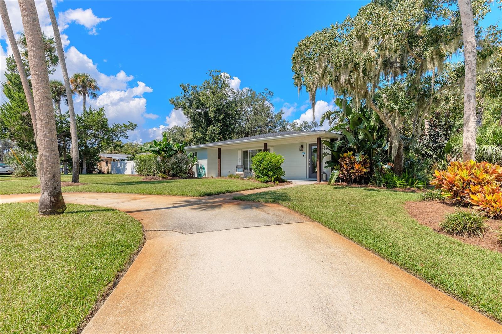Welcome to this beautifully updated 3BR/2BA coastal home offering style, function, and peace of mind. Recent updates include a roof less than two years old, newer HVAC, windows, updated plumbing/electrical, and 360° gutters. Located outside a flood zone with no history of flooding, this property ensures security and long-term value. The spacious lot with mature landscaping offers room for a pool, boat, or RV, plus two driveways, fenced yard, and sprinkler system. Inside, enjoy an open floor plan with luxury tile, crown molding, recessed lighting, plantation shutters, and a modern kitchen with granite and quartz counters. Bathrooms feature updated fixtures and soothing finishes. Prewired for a generator, the home blends comfort, efficiency, and reliability. The neighborhood offers Old Florida charm with parks, dining, and the beach just minutes away.