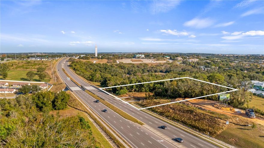 Premier commercial opportunity on US Highway 27 – Clermont's Growth Corridor.
Positioned at the epicenter of one of Florida's most dynamic growth markets, this exceptional 3+ acre commercial parcel offers a rare combination of strategic location, superior accessibility, and unlimited development potential. With prominent frontage along heavily-traveled US Highway 27 and additional access via Pitt Street, this C2-zoned property delivers the dual advantage of high visibility and flexible entry points that savvy investors and developers seek. Located just north of Highway 50 on the east side of US 27, this prime site benefits from approximately 44,000 vehicles passing daily in both directions, creating an unparalleled opportunity for businesses seeking maximum exposure. The property's C2 Commercial zoning opens the door to a diverse range of uses, allowing you to tailor development plans to capitalize on current market demands or position for future opportunities. Whether you envision retail, medical, professional services, hospitality, or mixed-use development, this versatile zoning provides the framework for success.
The surrounding area tells a compelling story of established infrastructure and accelerating growth. Within just a couple of miles, you'll find a thriving ecosystem of hospitals, medical offices, retail centers, and restaurants that serve the region's expanding population. The convenience factor extends beyond local amenities, with quick connections to major transportation arteries, including the Florida Turnpike, positioning your business at the crossroads of Central Florida's economic engine.
Clermont has emerged as one of Florida's fastest-growing cities, and the development activity surrounding this property reflects that momentum. You're investing in an area where commercial success stories are already being written, with thriving businesses on all sides creating a proven market and established customer base. The completion of Florida Turnpike Exit 278 in nearby Minneola has effectively opened the floodgates for expansion, with the region now perfectly positioned to capture growth radiating from the Orlando metropolitan area.
The scale of planned development in the immediate vicinity is staggering and speaks to the confidence major developers have in this corridor's future. In addition to the massive growth in Minneola, just seven miles south, the Olympus community adds another powerful growth driver to the equation. This 240-plus-acre sports-themed development is projected to generate over one billion dollars in economic impact through its combination of commercial, retail, and residential components. As thousands of existing homes continue to fill with families and thousands more housing units move through the development pipeline, the customer base for businesses along this corridor continues to expand exponentially.
This property represents more than just land; it's a strategic position in the path of growth. The combination of exceptional US Highway 27 visibility, flexible dual access, versatile C2 zoning, and proximity to unprecedented development activity creates a compelling investment thesis. Whether you're ready to break ground on your vision today or positioning for future appreciation as the market continues its remarkable trajectory, this three-acre opportunity delivers the foundation for commercial success in one of Florida's most exciting growth markets.