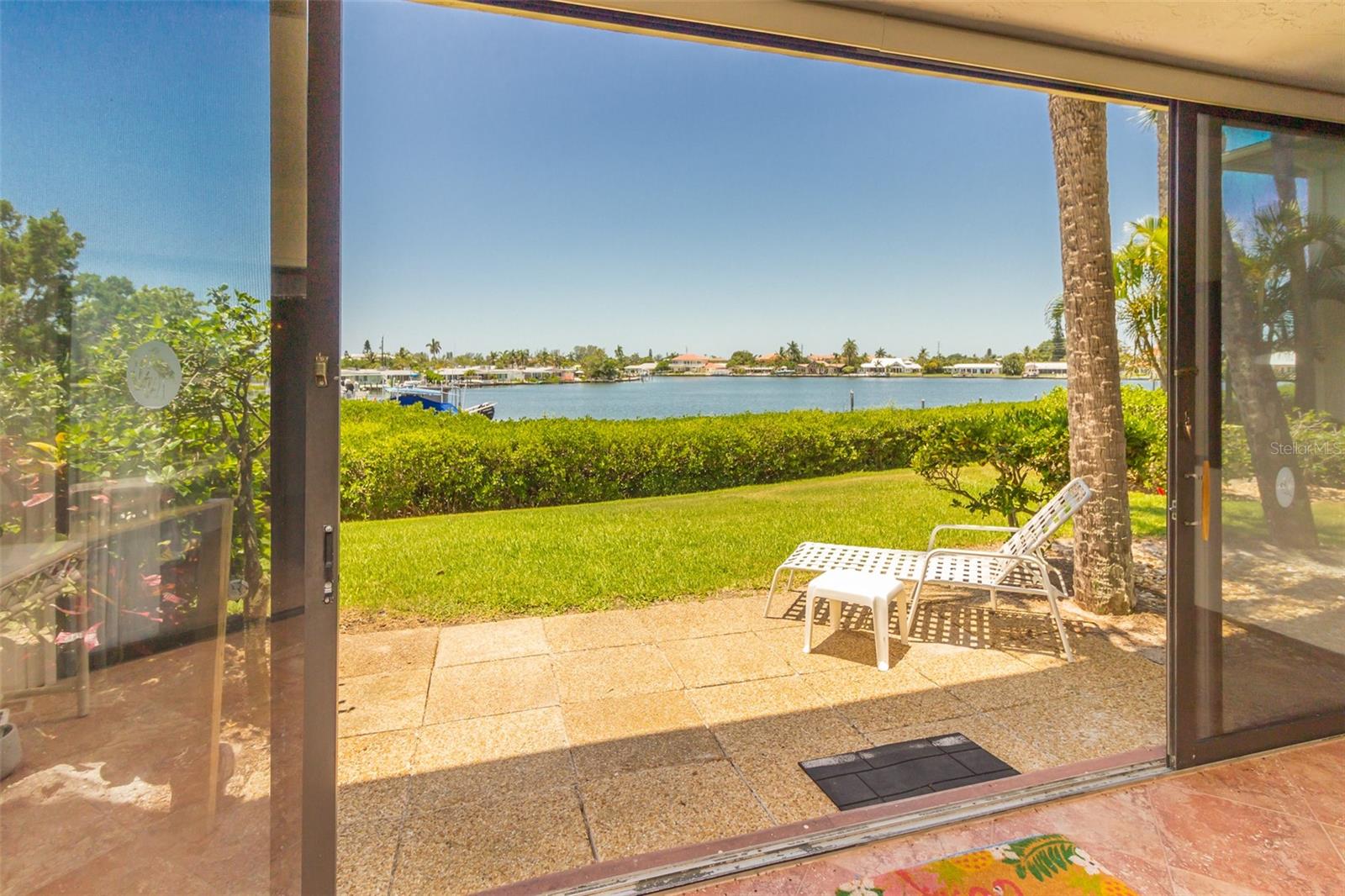 Paradise Remains! This lovely ground level, end unit in the highly sought Westbay Point & Moorings Condominium Complex is truly in a dream location. Facing west you will be delighted with nightly sunsets. Tucked into the bayou this unit was left high and dry during our last Hurricane season. Being an end unit with extra windows there is wonderful natural lighting and the unit itself is spacious and bright. There are two enclosed patios (one in the front and one in the back) that have sliders to either open up the area to the lovely breezes or close them for more living space. Just beyond the back sliders there is also a patio area outside for outdoor seating and solitude. The condo is completely tiled throughout and the kitchen has been remodeled with beautiful cabinetry and granite countertops. The bedrooms are split and each has a great deal of space and walk-in closets. If you are looking for a well maintained condo, look no further. This unit has been well taken care of. Unit is partially furnished and some furniture may not match the photos. Located in the heart of Holmes Beach, Westbay Point & Moorings is also a well managed community meticulously kept with great pride. You can bike or walk to many shops and eateries or hop on the trolley to go anywhere on the island. New roof and new A/C 2025. ** New Hurricane Roll Down Shutters have been ordered and will be included in the sale .** All assessments from storm repairs have been paid to date, as will future additional storm assessments, if any. ** Owner will consider financing **
