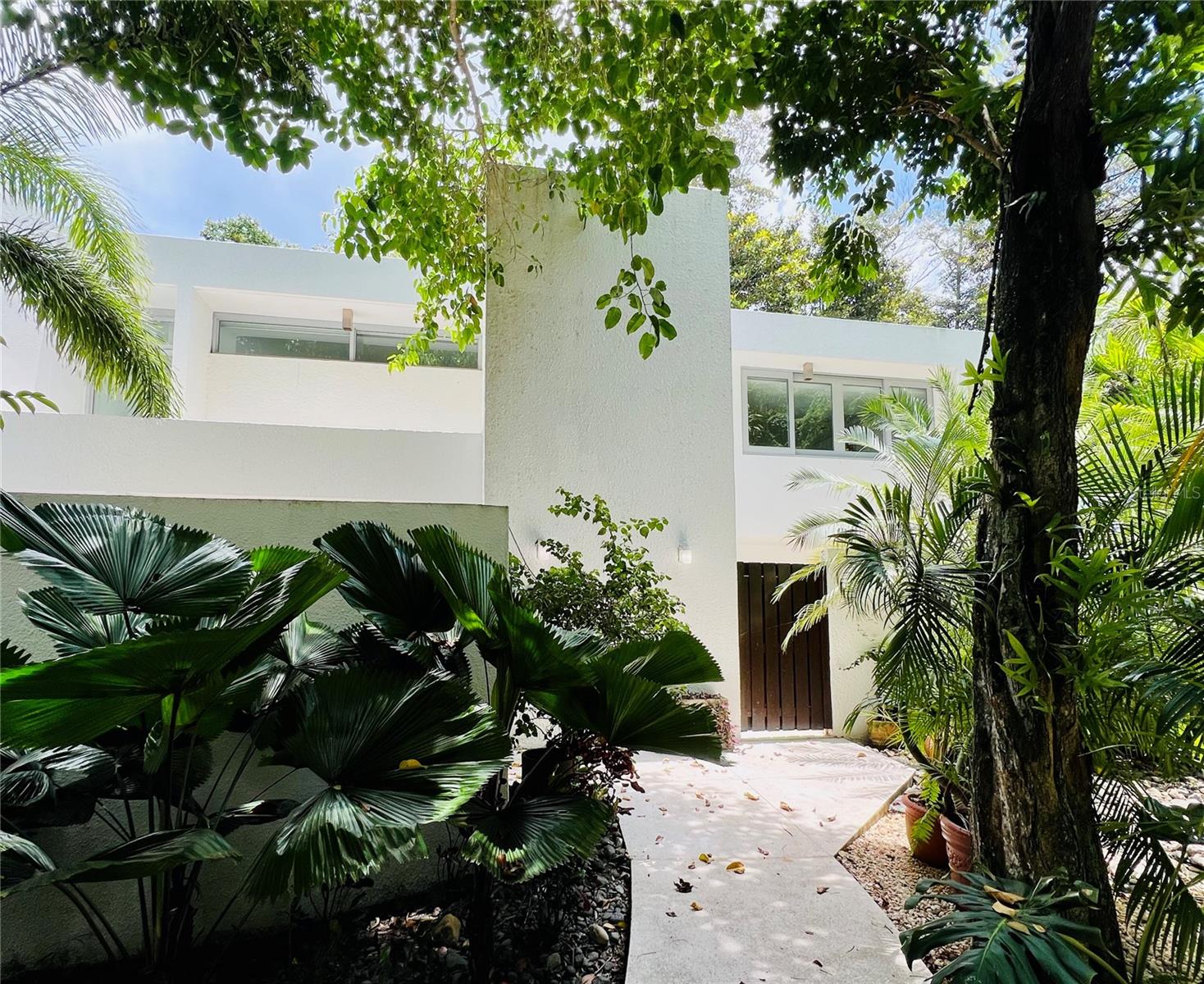 Experience luxury living at its finest in this exquisite property for rent located at Villa Dorado Resort in Dorado. Situated within the Dorado Beach development, this home offers unparalleled access to a wide array of world-class amenities that define the resort lifestyle.
Nestled along the picturesque coast, this property allows you to immerse yourself in the laid-back island lifestyle. Let the soothing sounds of nature and the vibrant flora of the resort community envelop you, or unwind on the terrace while gazing out at the panoramic ocean views. This turnkey property is a true gem, meticulously renovated and fully furnished to perfection.
The bright and contemporary floor plan features floor-to-ceiling windows that showcase stunning views of the lush gardens, manicured golf course, and sparkling ocean. Spanning two levels, the interior living space offers a seamless blend of comfort and elegance. The main floor hosts an expansive master bedroom with a cozy sitting area and luxurious master bathroom, a spacious living room with soaring ceilings, a dining room, and a well-appointed kitchen—all overlooking the golf course and ocean. Upstairs, you'll find three ensuite bedrooms, a laundry room, and a balcony with a relaxing sitting area where you can savor the ocean breeze.
Throughout the property, you'll be charmed by the tropical-chic decor that exudes warmth and style, creating a welcoming ambiance that feels like home. In addition to two assigned parking spots and generator, this extraordinary residence also comes with a golf cart, access to a community swimming pool, pickle-ball and tennis courts, nature trails, and direct beach access.
For those seeking the ultimate in luxury living, the owner can sponsor a Dorado Beach Membership with an additional security deposit, granting exclusive access to even more premium amenities and privileges. Don't miss this rare opportunity experience resort living at Villa Dorado Resort in Dorado, Puerto Rico.