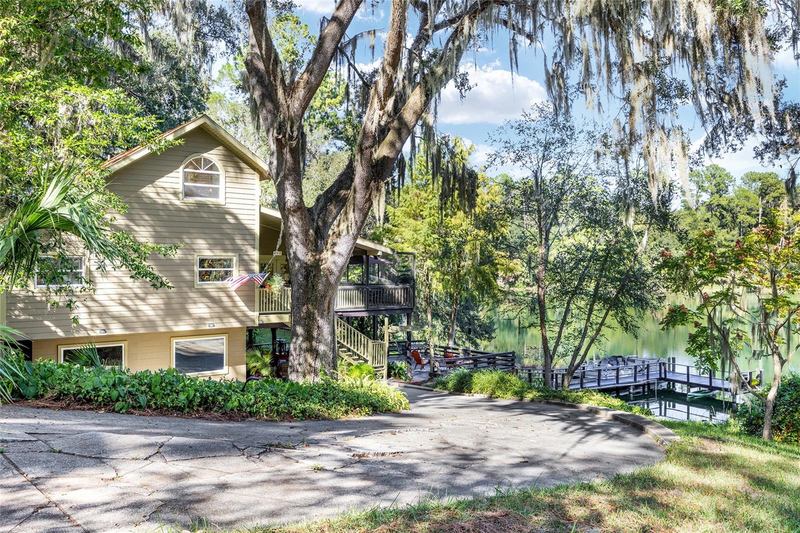 Discover this hidden treasure in Blue Cove, one of Dunnellon’s most coveted neighborhoods, featuring direct access to the crystal-clear waters of the Rainbow River just minutes from your dock. This tri-level, 3-bedroom, 3-bath home embodies the essence of Florida's natural beauty, providing an artistic and welcoming retreat like no other. Upon your arrival, you’ll be tempted to explore the exterior decks and soak in the waterfront views before stepping inside. Starting on the lower level, you'll find a private guest suite, perfect for hosting friends or family, with convenient access to the riverfront. As you ascend to the second level, the main living area greets you with high vaulted ceilings and stunning hardwood floors, imbuing the home with warmth and character that is often elusive. Expansive windows showcase panoramic views of the tranquil Blue Cove, presenting an ever-changing canvas of shimmering emerald hues throughout the day and lush greenery. The best part? Imagine yourself enjoying the screened-in patio at any time of day or season—ideal for savoring morning coffee, sunset dinners, or simply immersing yourself in the sights and sounds of the river. Climbing to the top, you will discover a spacious primary bedroom complete with an en-suite bathroom and incredible views of the cove. The home’s eclectic design radiates personality—perfect for those who value creative expression and a laid-back lifestyle. Whether you're kayaking, tubing, or leisurely floating in your own backyard, this property promises the ultimate waterfront experience.