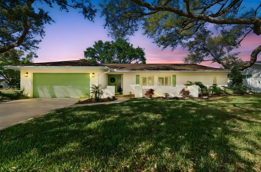 Situated beneath a canopy of mature oaks in the highly sought-after Del Oro Groves neighborhood, this beautifully updated residence offers 4 bedrooms, 3 bathrooms, a 2-car garage, and 2,307 heated square feet (2,838 total). Designed for comfort and functionality, the spacious split-bedroom floor plan is filled with natural light and features rare terrazzo flooring throughout the main living areas, fresh interior paint, crown molding, new interior doors, and updated trim completed in 2022. The renovated kitchen includes new cabinetry, granite countertops, pantry storage, modern appliances, and a gas range. An inside laundry room with utility sink and gas dryer adds everyday convenience. The primary suite offers custom wall detailing and two generous walk-in closets, while all three bathrooms have been updated with new tile showers, vanities, fixtures, lighting, and mirrors. A Jack-and-Jill bath retains a tub for flexibility. A standout feature of the home is the redesigned Florida room, showcasing a high ceiling with impact-rated transom windows and sliding doors that open to the backyard. Outside, the completely renovated pool and patio (2022) create a private outdoor retreat with paver decking, sun shelf with umbrella holder, bubbler, LED lighting, variable-speed pump, and new filtration system. Extensive exterior improvements include new stucco and paint, impact-rated windows at the front and poolside, impact sliders in the Florida room and rear bedroom, custom aluminum Bermuda shutters, new aluminum gutters with leaf guards, updated landscaping with new sod, and a sprinkler system supplied by both well and gray water. A new potable water line to the home was also installed. The garage has been upgraded with a hurricane-rated door, Spartan floor coating, new electrical panel, electric vehicle charger, and tankless gas water heater. Ideally located near Downtown Safety Harbor, this home is a short bike ride to shops, dining, and waterfront parks, within walking distance to Ruth Eckerd Hall, Del Oro Park, and the Ream Wilson Trail, and approximately 20 minutes to Tampa International Airport. This move-in-ready property offers a rare opportunity to enjoy a thoughtfully updated home in one of Clearwater’s most desirable established neighborhoods.