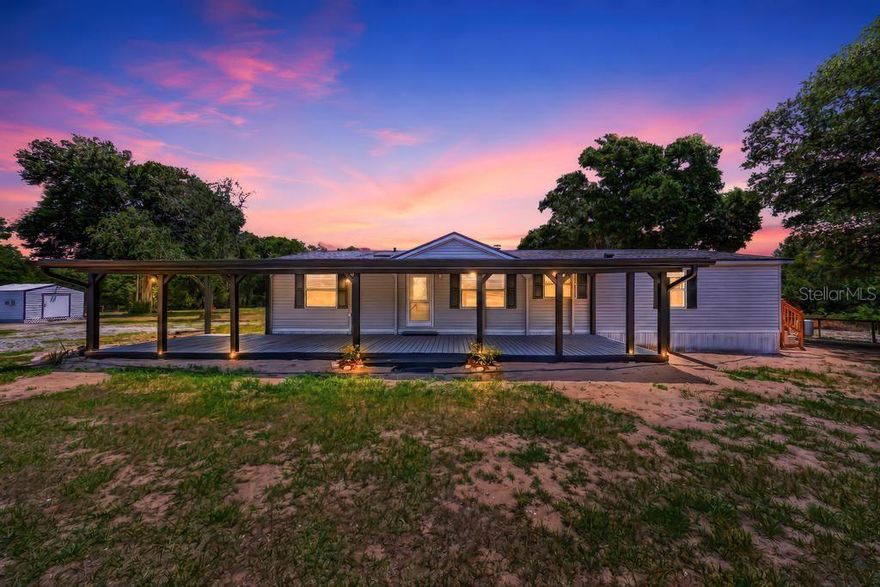3.4 Acres of Cleared, Level AGRICULTURAL land in RURAL Lake County FL! FENCED with a Top-Board and 80x26 BARN so bring the HORSES! FULLY RENOVATED 3 Bedroom / 2 Bath - 1800 sq ft MH. Home has been completely gone through and repaired and updated! Large Kitchen with Newer Appliances, Cabinets and gorgeous Butcher Block Counters (hand-rubbed with Bee’s Wax – must see!) New Tile Backsplash. Lots of cabinets and a pantry! Room to eat in but no need with the large Dinning Area! Living room offers a remodeled Wood-Burning Fireplace with Fireplace Blower (Heat-A-Lator) to recirculate the heat of your fire throughout the room! New Stone front, Hearth and Mantle really make a beautiful center piece! French Doors to the NEW 10x12 Deck with Copper Topped Railings. You will be drawn to spend time in the Primary En-suite with the Walk-In Closet and adjoining BONUS Room! Will make a fabulous Exercise room, Home Office, Dressing room or just a luxurious and private relaxing area (think private Spa)! Primary Bath offers Newer Counters, Double Sinks, a Shower with DOUBLE SHOWER HEADS, Décor Shelving and nice Linen Closet. Split Plan has 2 more Bedrooms on opposite side of home – both have Walk-In Closets and nice Wainscoting that give the rooms a finished appeal. Guest Bath has Newer Cabinets, lighting, New Faucets and tub & shower combo and a Sky Light. Indoor Laundry with New Washer & Dryer Hookup, New Entrance Side Door with window, New Cabinets for storage and shelving. This Home is where everyone will want to gather for fun and friendship! Throw your Celebrations on the completely rebuilt Front Covered Deck (12x48). The Barn and attached Shop/Tack-Feed Room is 80x26! Entire Barn sits on a concrete pad. Roof is metal. Half (40x26 ft) is 3 sided and has Rubber Stall Mats under shavings. Build multiple stalls or use as-is as a Run-In. Could also use for parking equipment or MANY, many toys! The other half is enclosed with 220 amp running to it. Concrete floored, garage door in front and walk through door into the other covered area. Barn has electricity and water run to it. Metal Shed by house is dry and would make a great “she-shed”.  So many updates! This was an entire property renovation. Must see to appreciate! New Trailer Skirts. New Back Gutters. New 10x12 back porch with Copper Topped Posts. Complete rebuild of Front Porch 12x48. New front door and New Screened Door. New Side Entrance Door. All Interior Doors are Solid Hardwood. Upgraded Exterior Electric connections. New plumbing Fixtures throughout house. Laundry Room has New Cabinets, as well as Washer and Dryer connections and Dryer vent pipe. New Backsplash in Kitchen. Complete rebuild of Front Porch. All new trim work throughout house – with newly painted interior. All windows come with new screens and window blinds. New Smoke Detectors (hardwired, not battery). Upgraded and refurbished working Water Softener. New post and top board wire fencing installed in front pasture and barn area with new gates. Pastures have been cleared of debris, leveled and seeded. AC 2021 – New Compressor installed 2026. Roof 2017. Sidebar – pastures have been seeded – just waiting for rain! Horse Riding Distance to Sawgrass Preserve. Public Boat ramp on Lake Yale around the corner. Ocala National Forest a couple of miles. Less than 9 miles to Publix and Downtown Eustis for Shopping and Dining.
