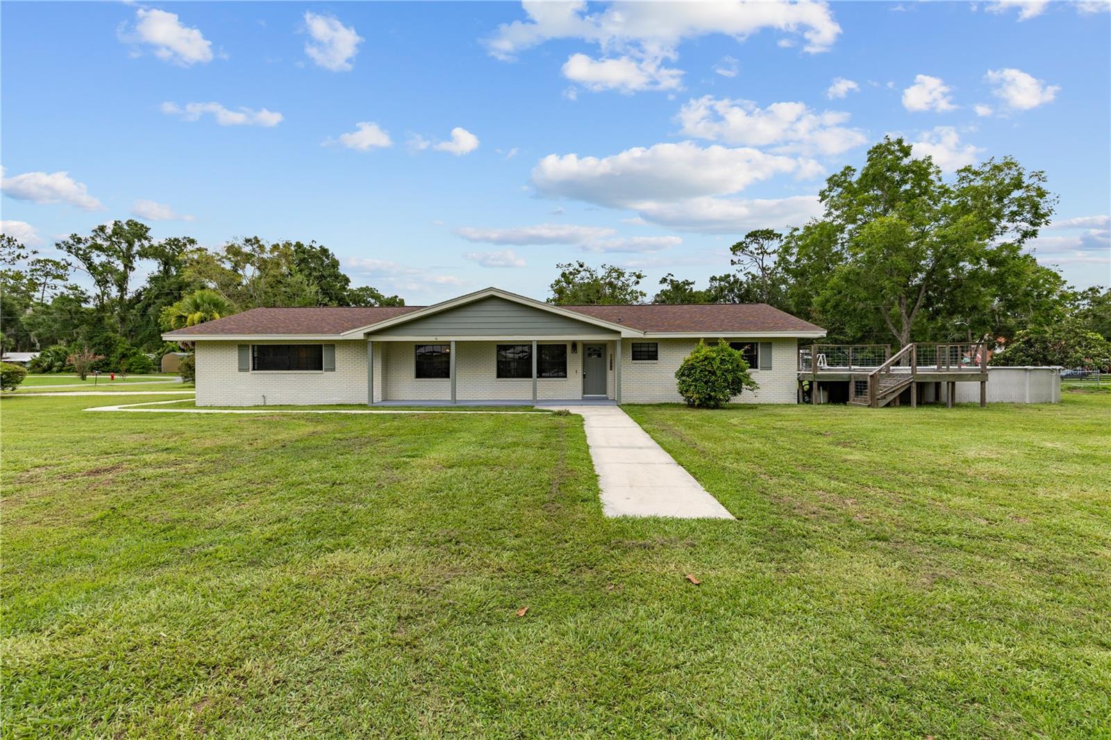 Spacious 3BR/2BA home on nearly 3/4 acre—entire city block—in the heart of Trenton! Solid concrete block & brick construction with a 2024 roof and 2025 HVAC. Interior offers large bedrooms, an open & functional layout, and a spacious kitchen with newer stainless appliances. Covered back lanai overlooks the fenced yard, above-ground pool, and wood deck—perfect for entertaining. Plenty of room for pets, gardening, or play. Includes 2-car garage & paved drive. Rare in-town privacy with quick access to top-rated Gilchrist County schools, the Suwannee River, and the Gulf Coast.