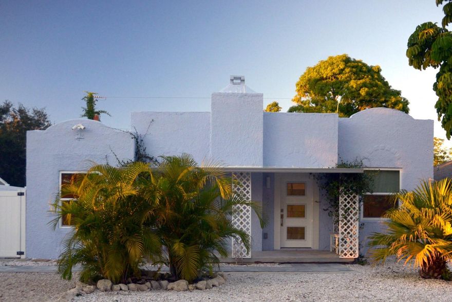 Don't miss out on this unique and charming, early 20th Century Mediterranean style hacienda featuring a fully-renovated interior that gives it a modern cottage feel. This beautiful and serene 2/1 home is just minutes from world renowned beaches and offers an abundance of natural light, high ceilings, and luxury vinyl flooring throughout.  New French doors lead to the tropical oasis that awaits out back!  The backyard is made private by mature landscaping and a newly installed 9' vinyl privacy fence, and offers a brand new deck space with a pergola that leads to a large tiled outdoor shower.  The bright and modern kitchen features new appliances and granite countertops with a waterfall design. The possibilities are endless thanks to the open floor plan, which affords the flexibility to accommodate a variety of needs and tastes.  There is no HOA, so you will not have to worry about community rules or added monthly fees, making this a great home for full time living, a vacation home or a potential income property.  Upgrade highlights include a new A/C system (2024); whole-home water treatment system; newly installed double-pane high-impact windows with designer grade privacy shades; enlarged bathroom (2024) with designer tub; sealed roof with new gutter system; new irrigation system; new high-end washer and dryer; new hot water heater; and fresh wallpaper and paint throughout. Additionally, 240v wiring has been installed and is ready for your Level 2 EV charger. Your new home is conveniently situated just minutes from downtown (6 minutes/2.8 miles), Holmes Beach/Anna Maria Island (12 minutes/6.2 miles), and the Sarasota/Bradenton International Airport (25 minutes/11 miles). Schedule your viewing to check out this beautiful tropical oasis today. This is the opportunity and Florida lifestyle dream you've been seeking.